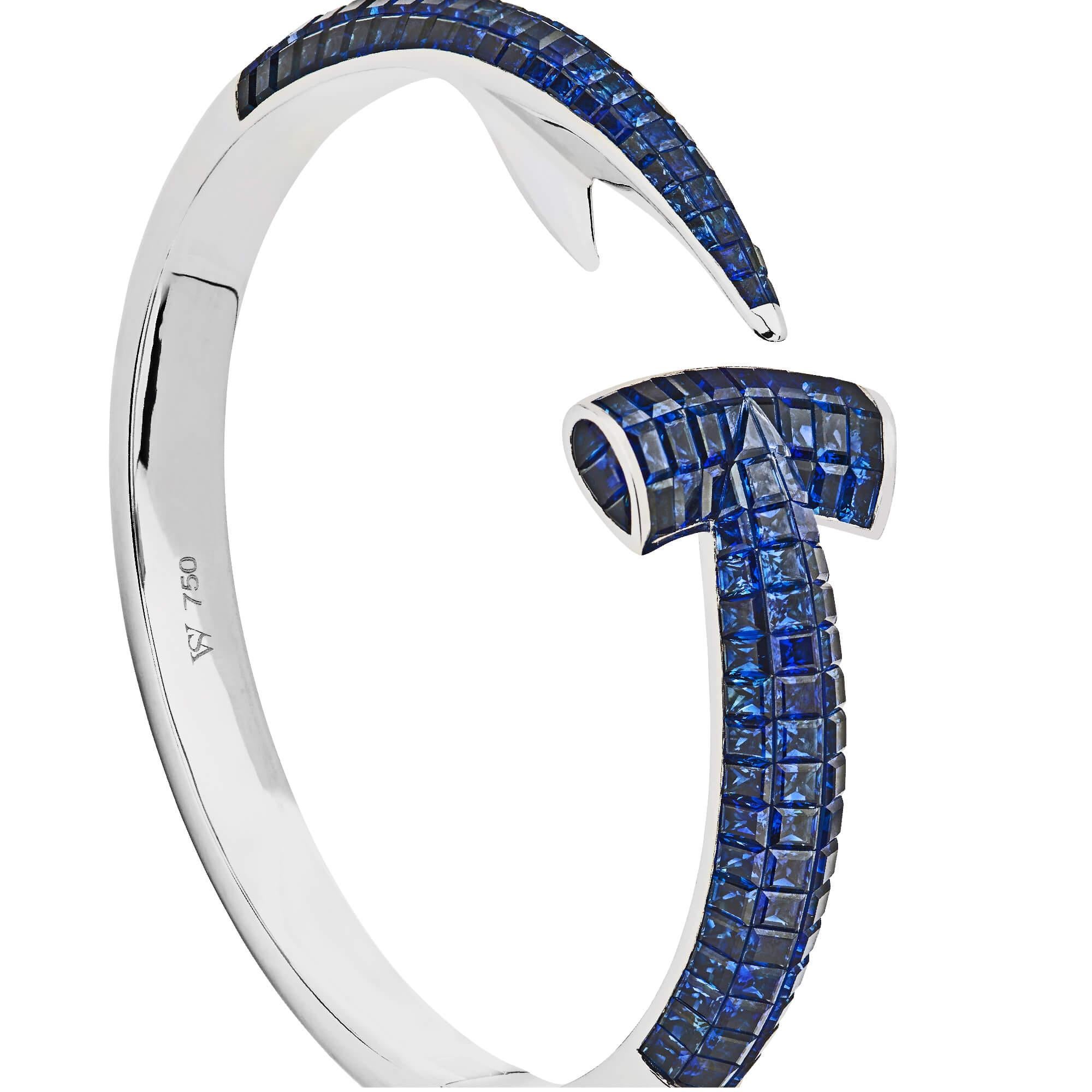 Dive for precious bounty with the Hammerhead Sapphire Bangle. The Hammerhead sapphire bangle combines Webster's love of the aquatic with a sleek silhouette and intricate gem setting.

Hand crafted in 18ct white gold and completed with square cut
