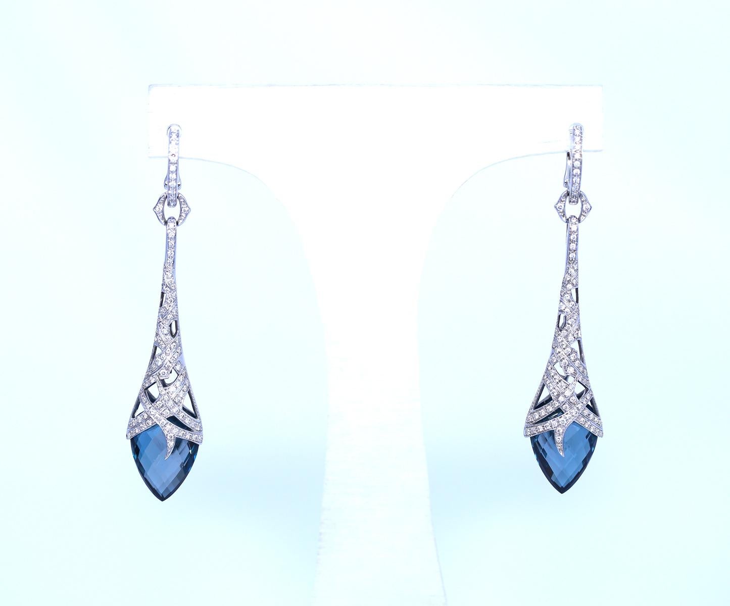 A Pair of Blue Topaz and Diamond 'Thorn' Earrings by Stephen Webster. Created around 2018. Two oval-shaped faceted blue topaz drops, total of 22.18 Carats and Round brilliant-cut diamonds, total approximate weight of 1.00 Carat. Mounted in 18 Karat