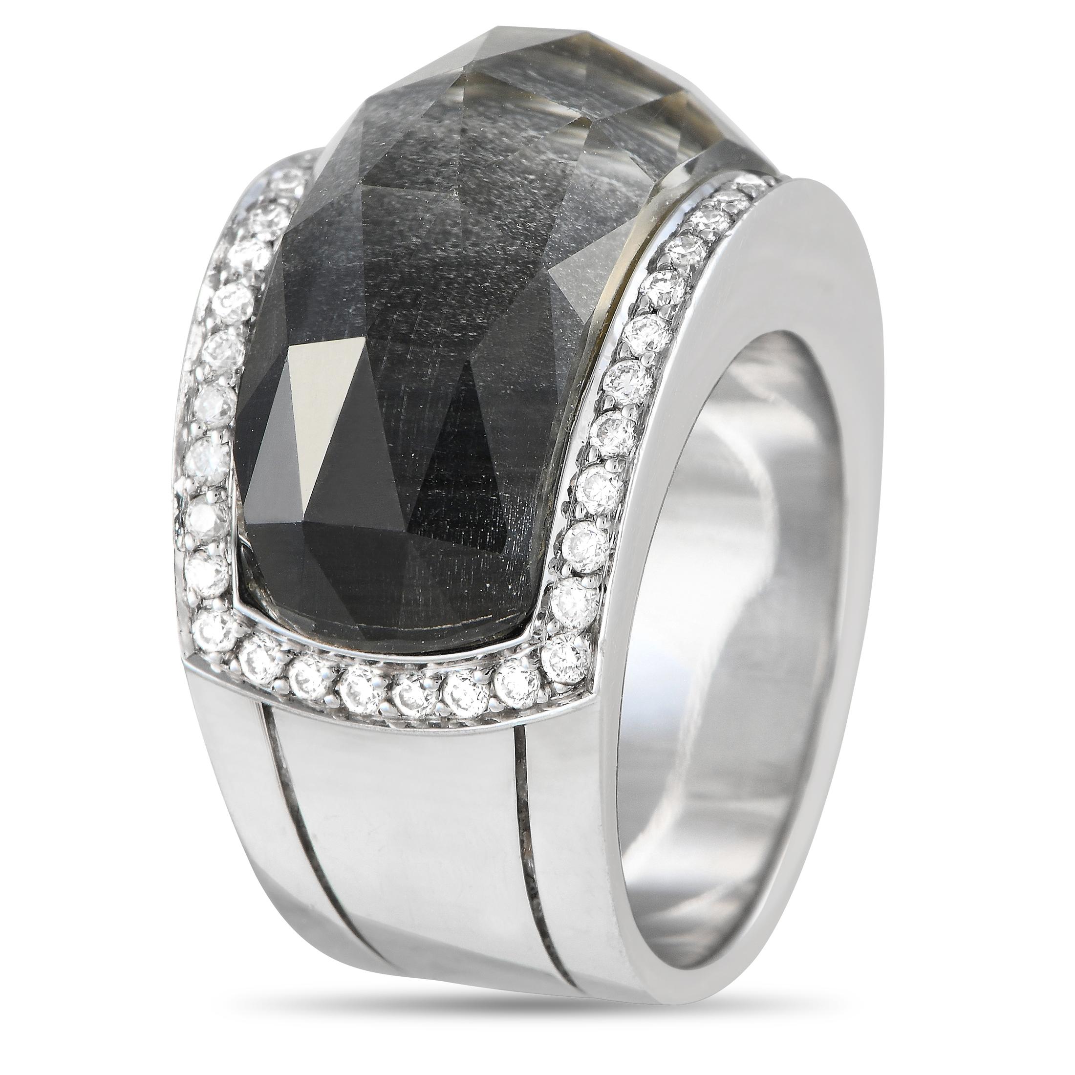 This Stephen Webster Crystal Haze offers a beautiful combination of colors and textures. A large crystal with a black backing serves as a stunning focal point, while a series of diamonds totaling 0.60 carats add sparkle to the edges. The simple 18K