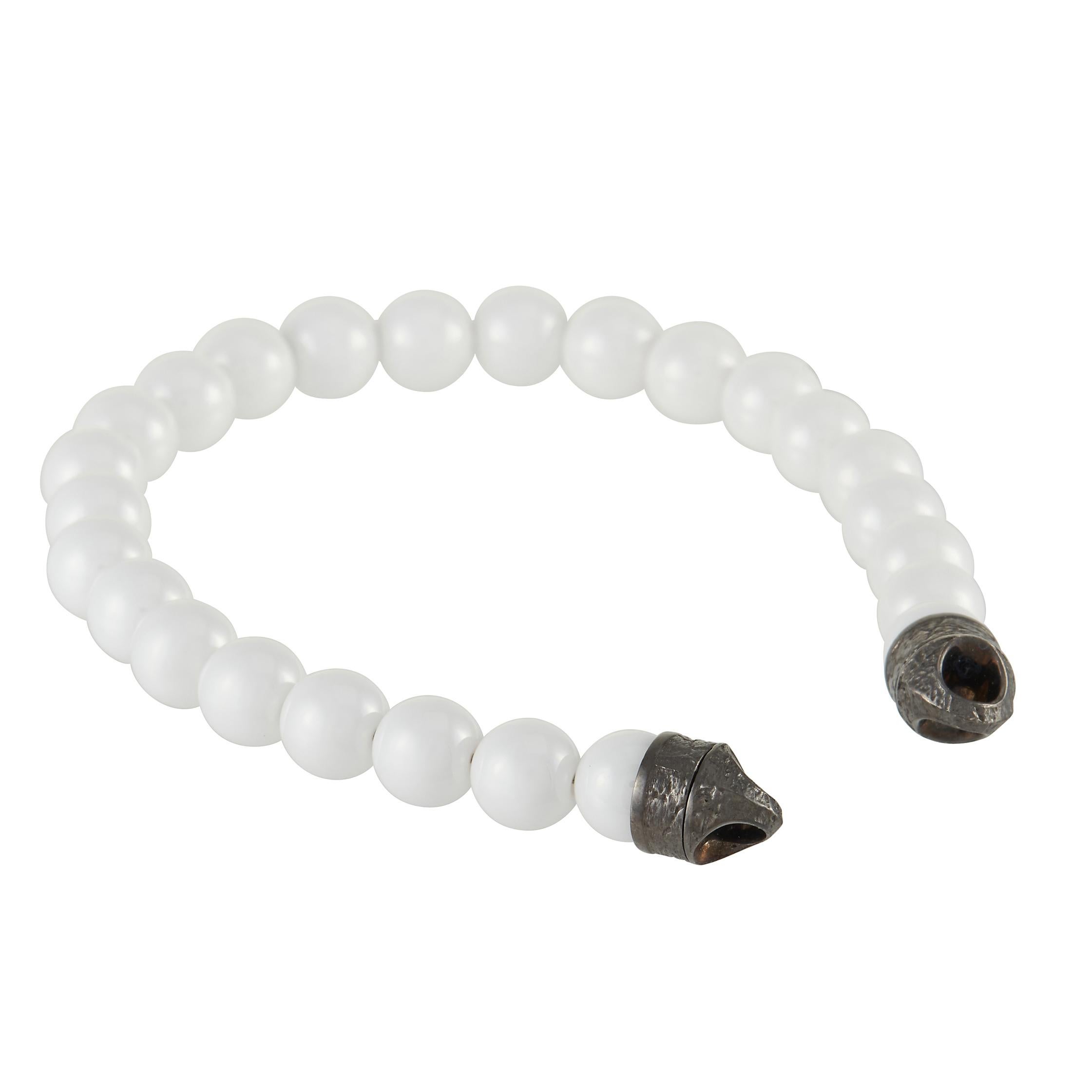 There’s something crisp, cool, and confident about this Stephen Webster England Made Me bracelet. Comprised of white ceramic beads, this minimalist design is devoid of a clasp system. It measures 8” wide and will pair beautifully with any look. 