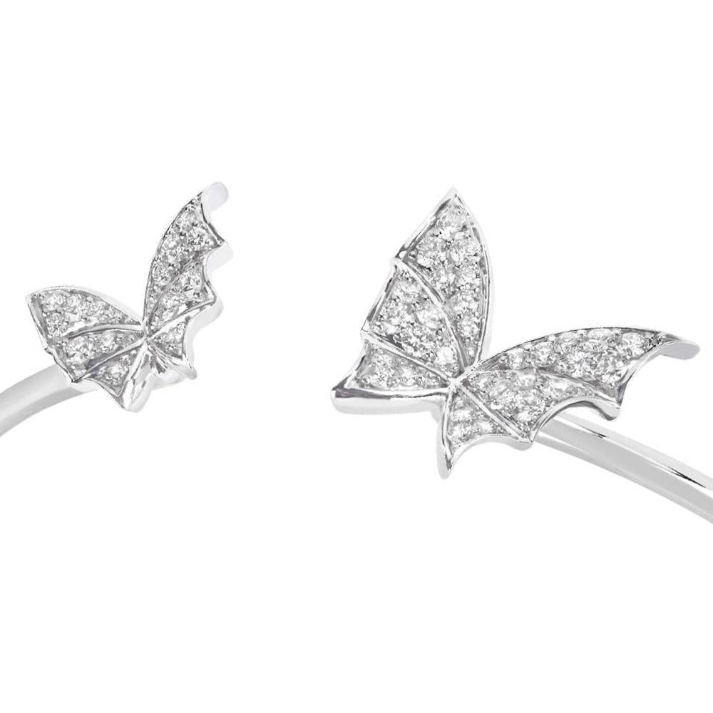 The 'Fly By Night' collection is a celebration of nocturnal, winged creatures from the darkest depths of a magical forest. This 18ct white gold bangle features two white diamond pavé bat moths offering a luxurious take on the enchanting