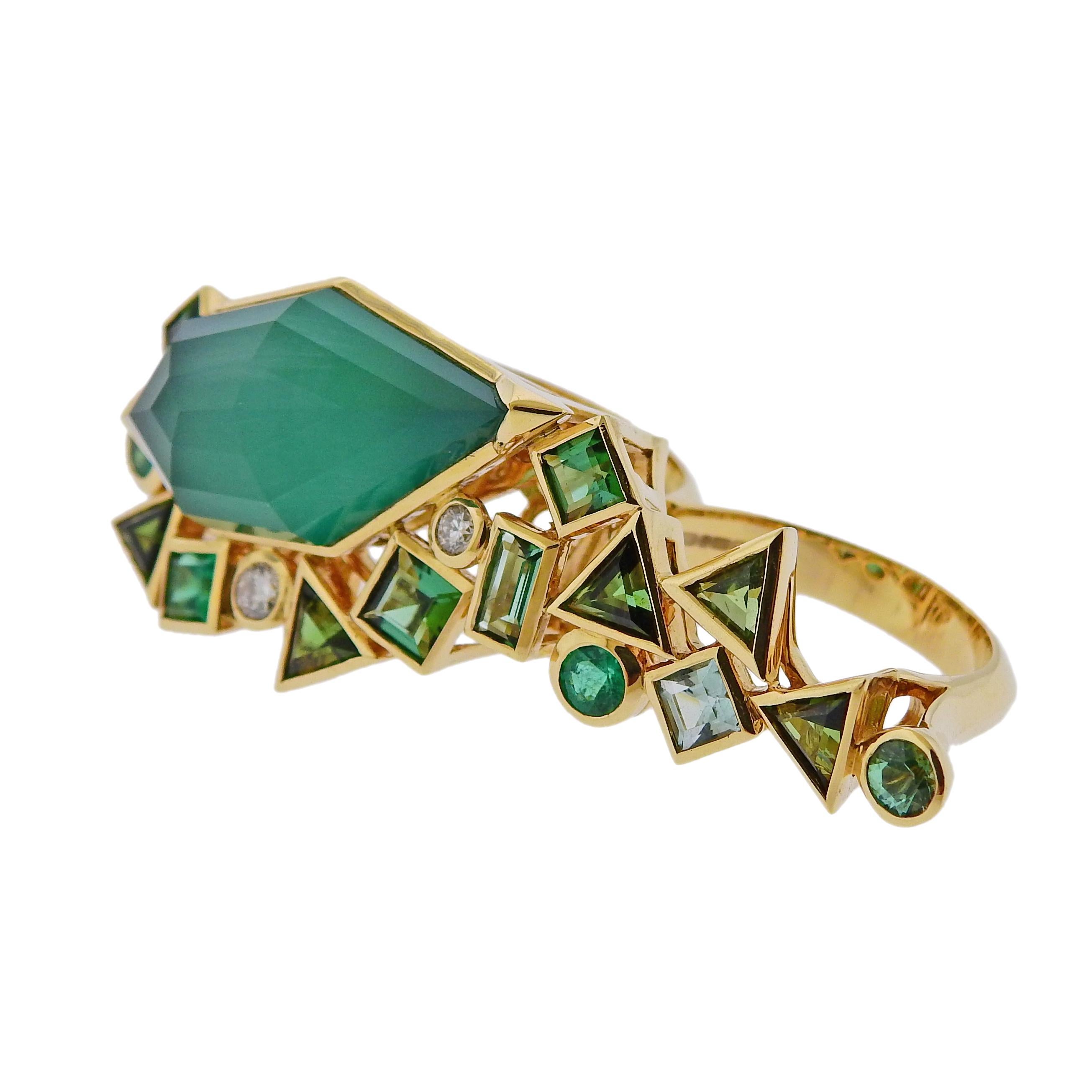Brand new 18k gold Gold Struck two finger ring by Stephen Webster, set with approx. 0.16ct diamond, green agate, emerald and tourmalines.  Retail $11500. Comes with original packaging.  Ring size - 7 and 6 , top of the ring - 21mm x 49mm. Weight is