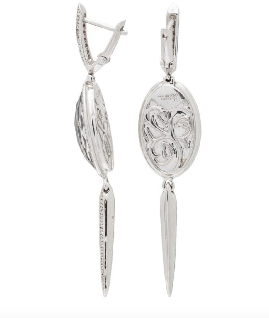 This edgy design featuring an oval rose cut rock crystal over hematite are created by Stephen Webster. These earrings are pave set with 152 top quality round brilliant cut diamonds weighing 1.30 carats total. Crafted out of 18 karat white gold,