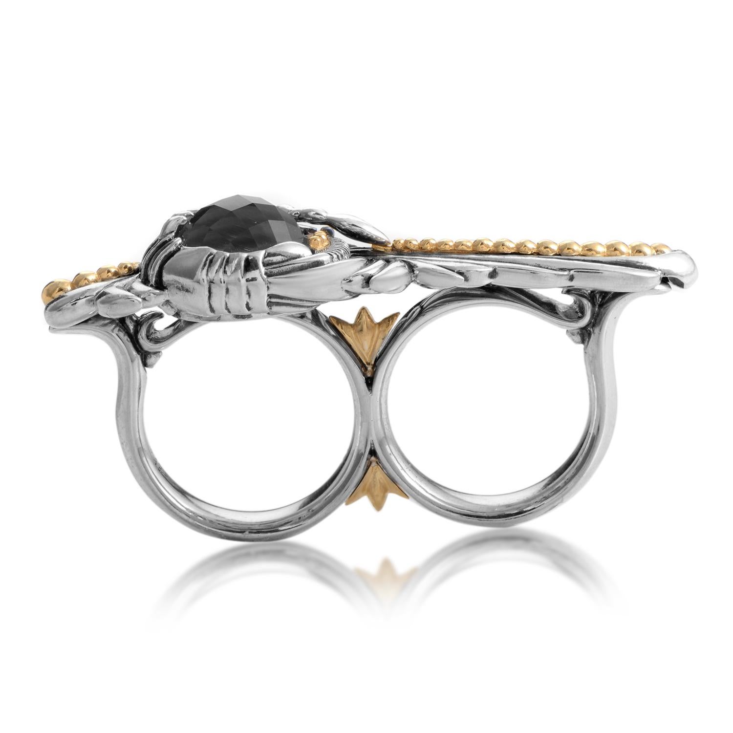 Magical in its elegance and ethereal colors, this gracefully designed Stephen Webster two-finger ring is a stunning example of classic style being made contemporary. The focal point is the urbane brooch style design that holds a faceted stone gray
