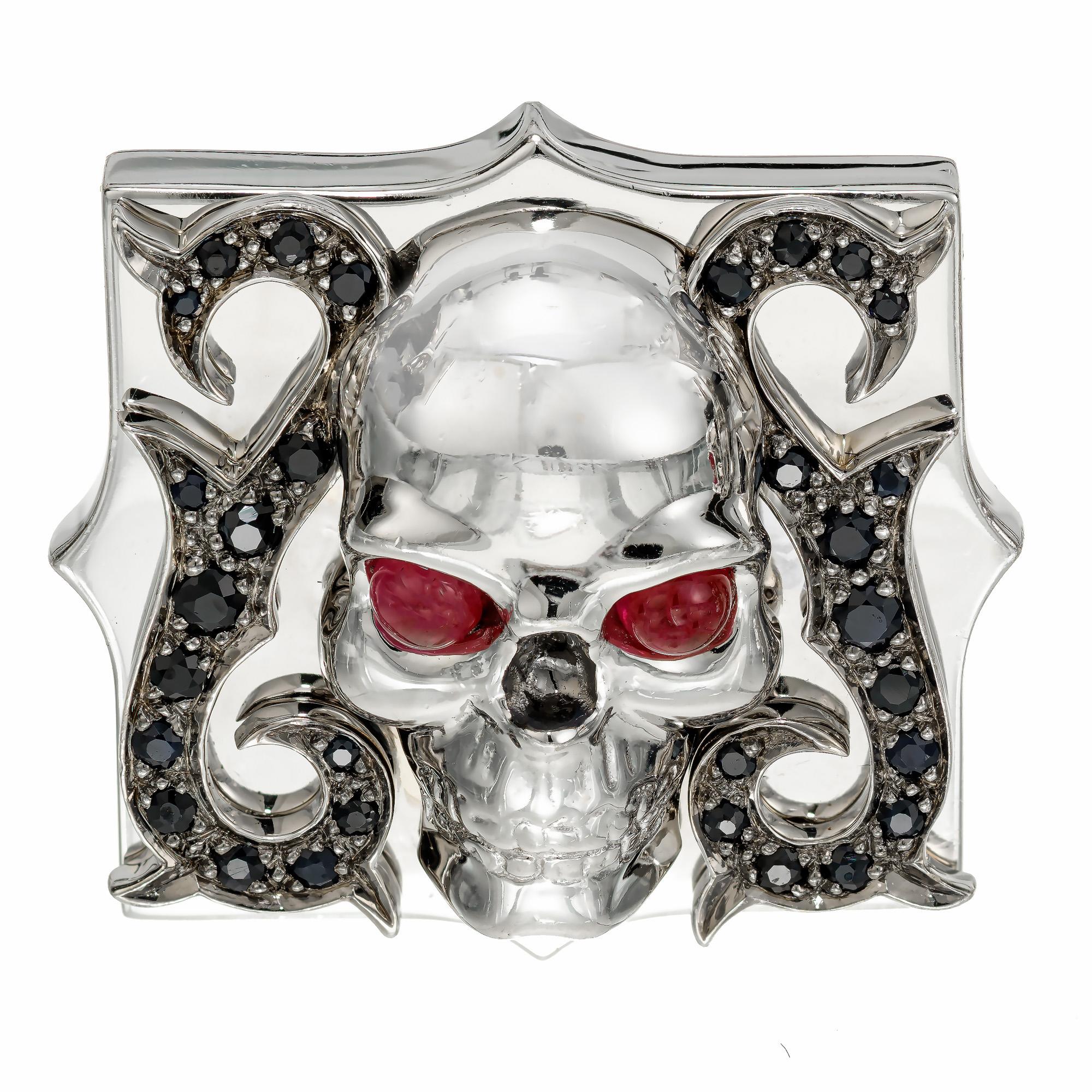 Stephen Webster 18k white gold heavy solid 18k white gold skull cufflinks. 4 cabochon ruby eyes accented with 60 round sapphires. 

4 round cabochon Rubies 3mm
60 round sapphires, approx. total weight .60cts
18k white gold
Hallmark: SW 26048
41.0