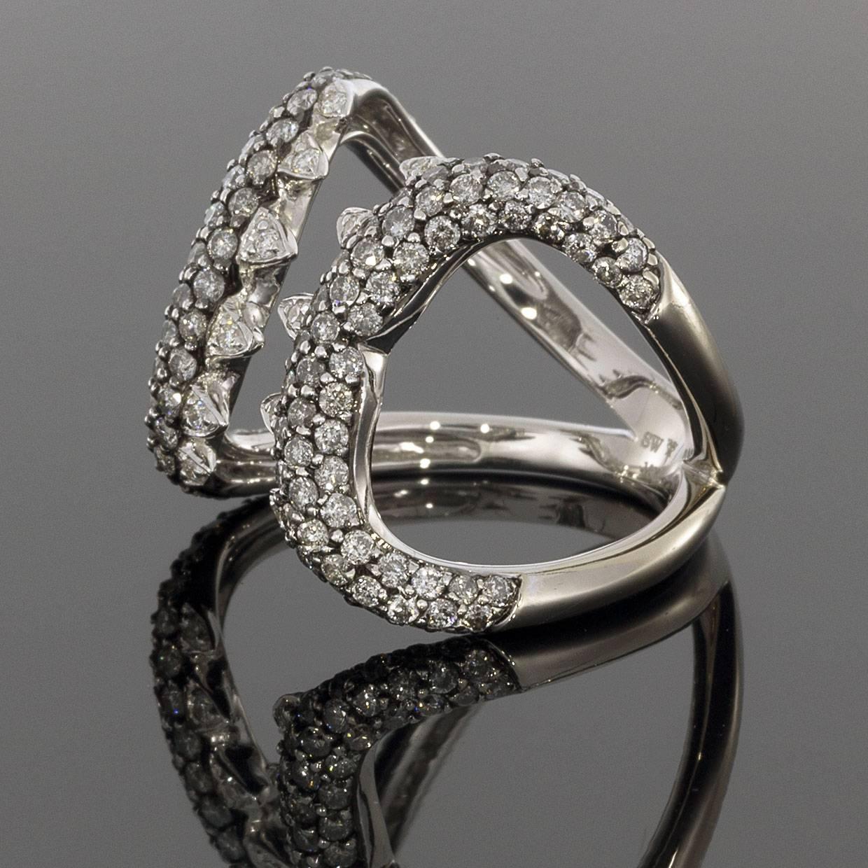 This gorgeous diamond fashion ring is sure to catch your eye from every angle! The unique shark bite design hugs the finger in sparkling 18K white gold. It's from the Jewels Verne collection from British designer Stephen Webster. The stone is set