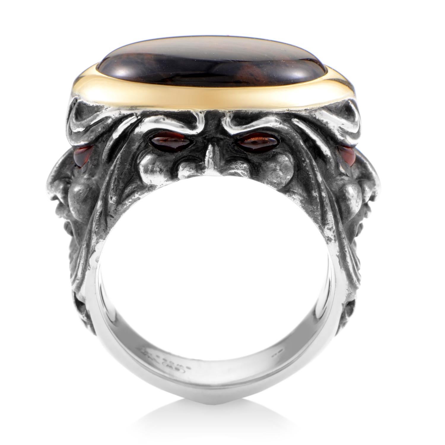 Daring in its astounding depiction of faces with piercing garnet eyes, this amazing silver ring from Stephen Webster boasts an appearance that honors the brand's spirit, with the mesmerizing spiderman jasper central stone surrounded by brilliantly