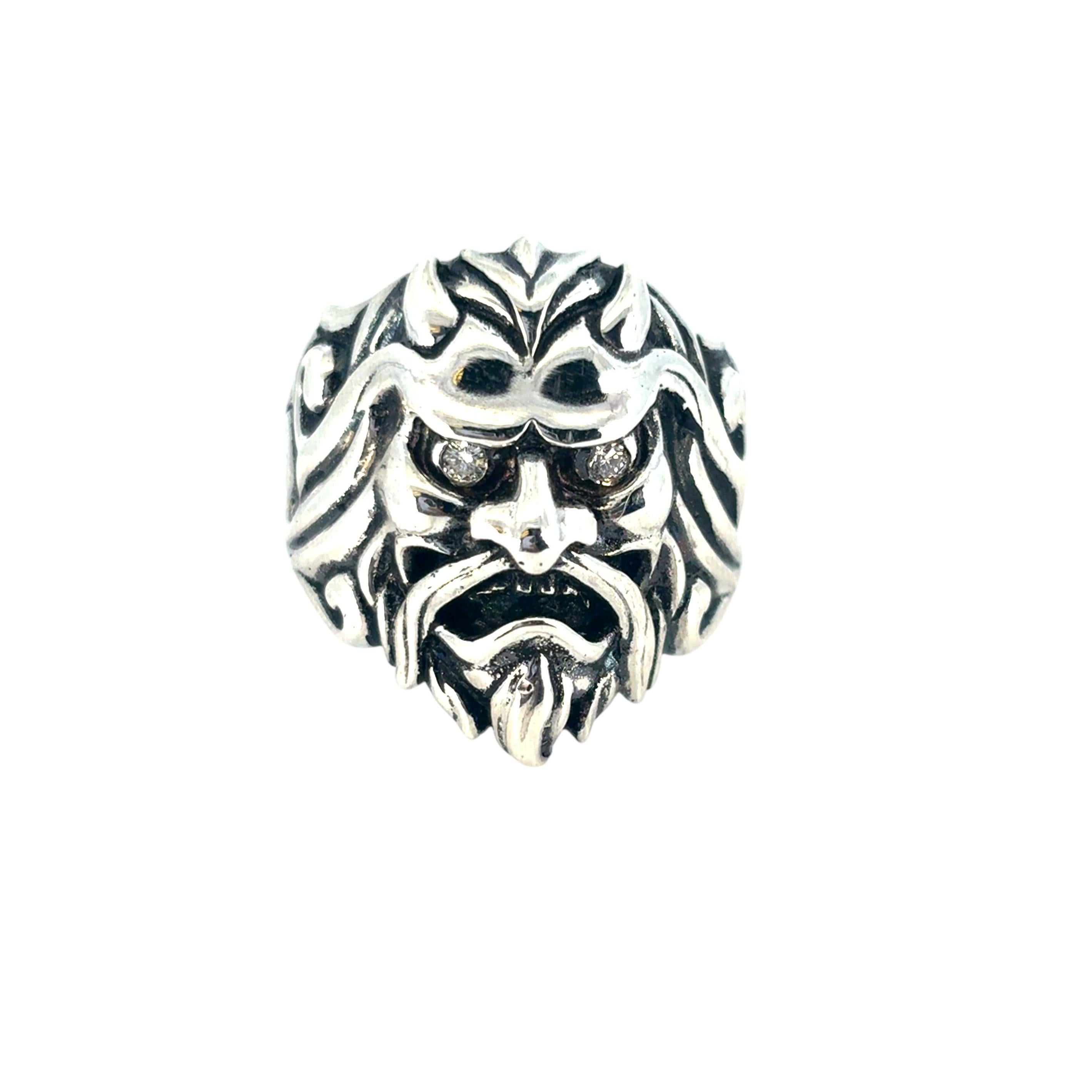 This Stephen Webster Mask Ring is in excellent condition and is ready to ship!

Designer: Stephen Webster
Style: Japanese Warrior Mask featuring two diamonds for the eyes.
Ring Material: Sterling Silver
Diamond Details: This ring features two round