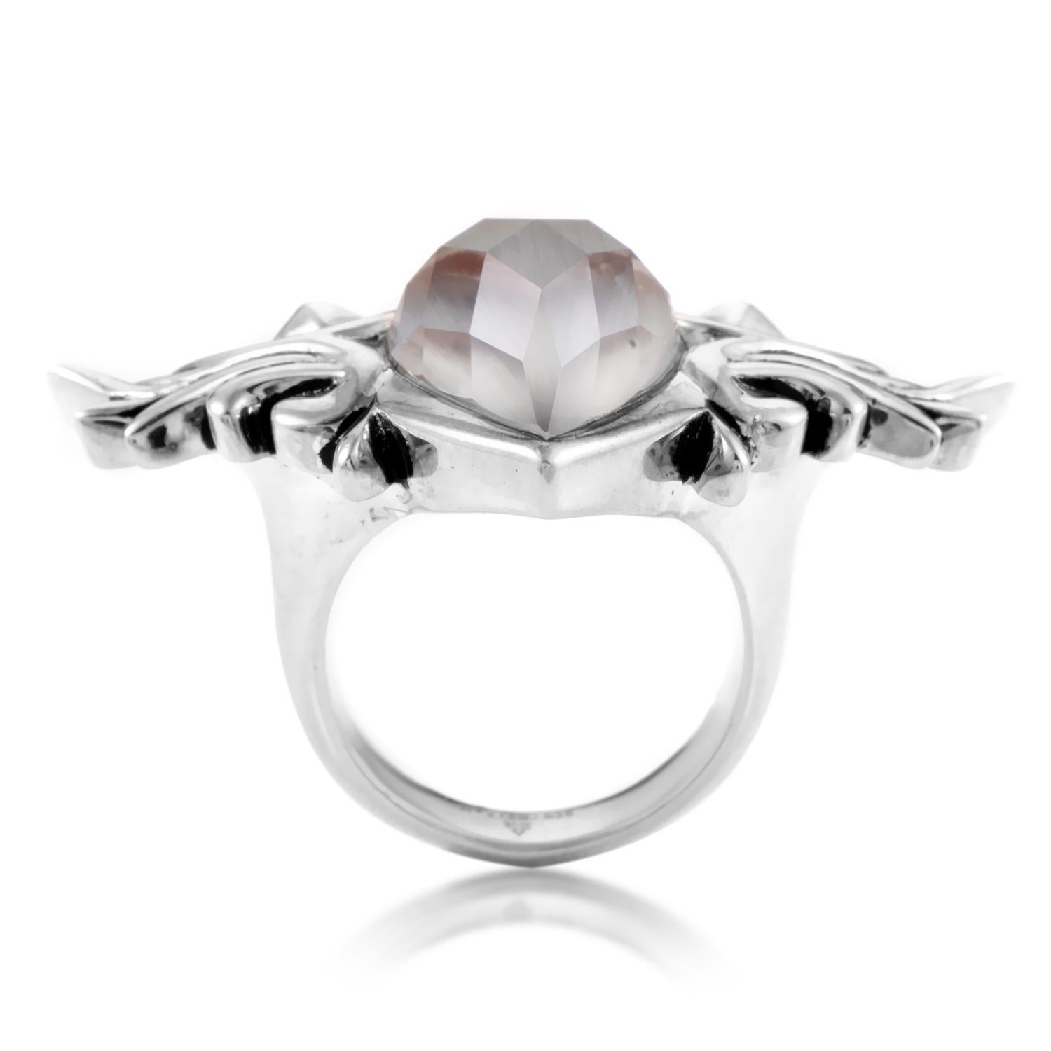 The elegance and daring edge of this ring is impressive in its heraldry to Stephen Webster. The pear cut, multifaceted stone gray cat's eye quartz is otherworldly in its own beauty. The sterling silver ring boasts elaborate detail on either side of