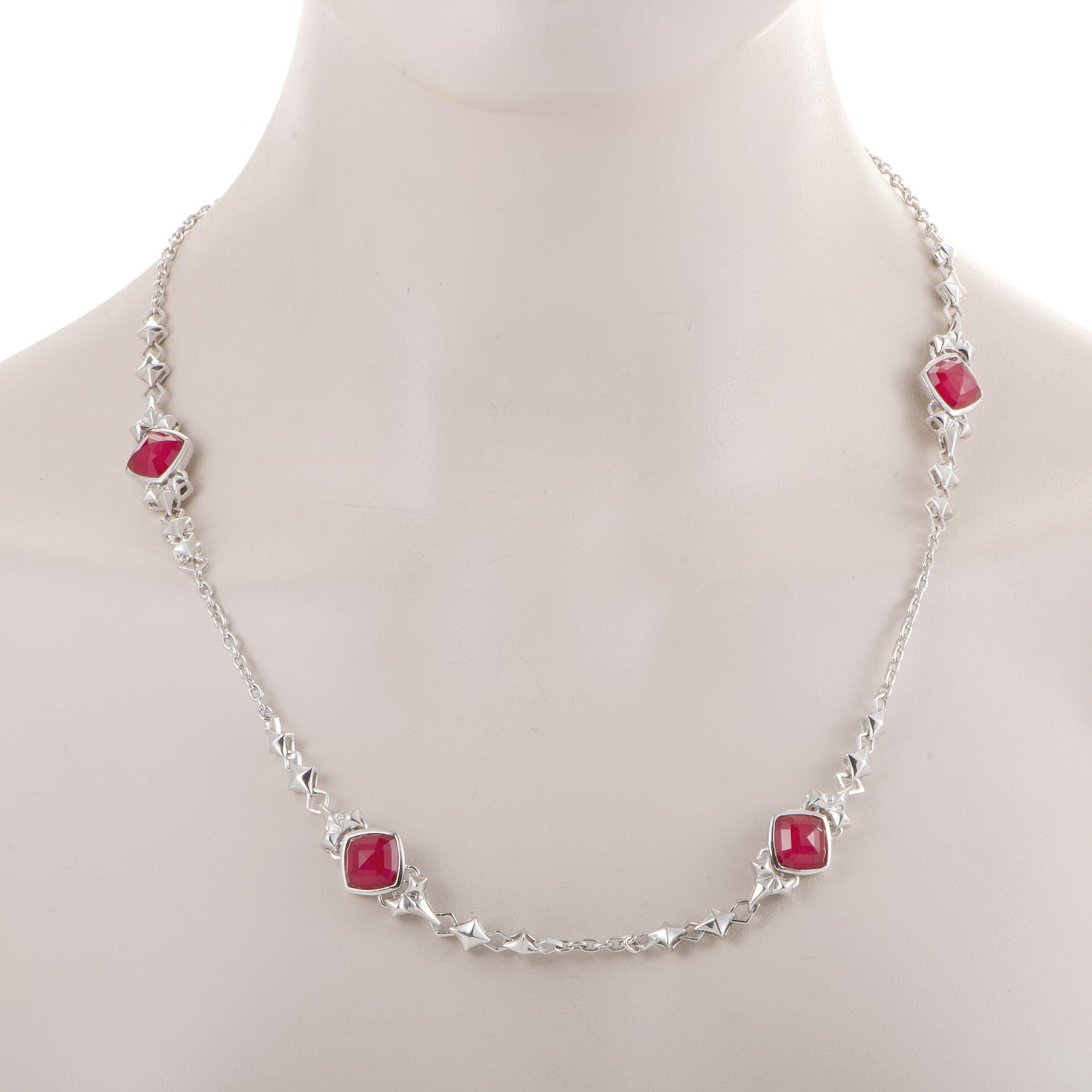 Standing out in brilliant fashion against the wonderfully bright backdrop of white rhodium-plated silver and quartz, the amazing synthesized red coral stones lend their passionate spirit to this marvelous necklace from Stephen Webster's 