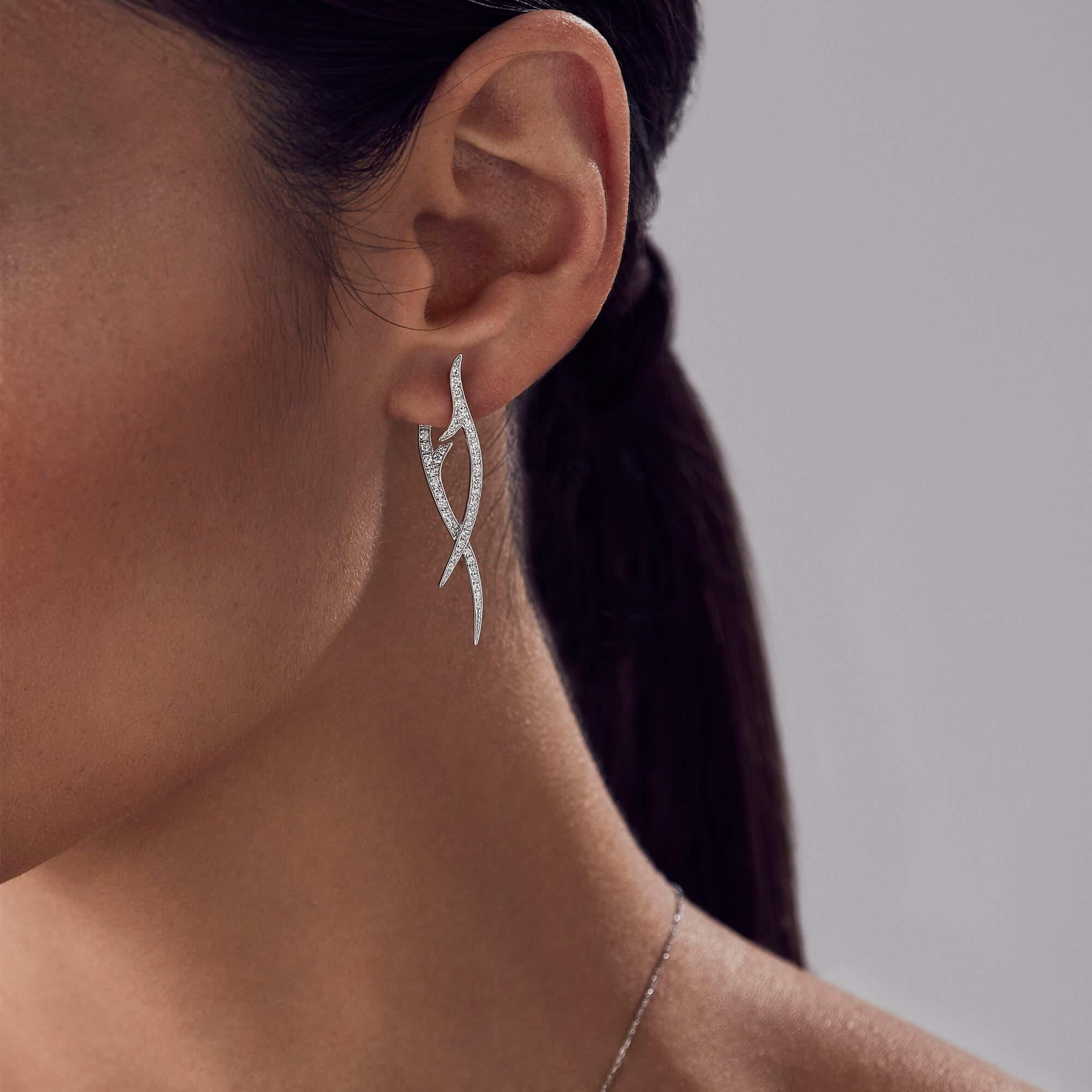 Thorns are explored in exquisite detail in the Stephen Webster drop earrings to luxurious effect. With Stephen Webster's visionary design philosophy, the earrings combine 18 karat white gold with white diamond pavé (0.60 carats) bringing impeccable