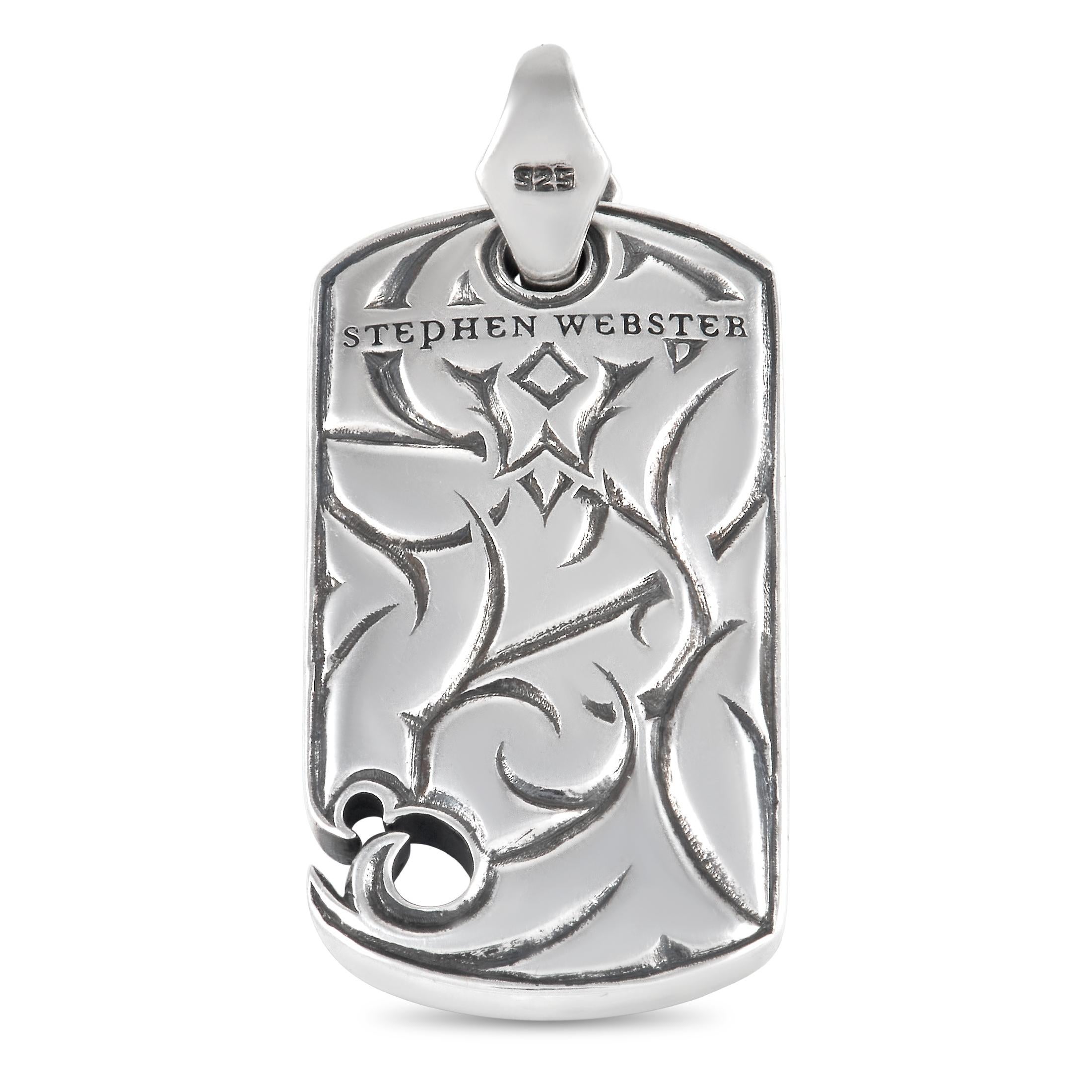This piece from the Stephen Webster Thorn collection possesses a bold, confident sense of style. Crafted from sterling silver, this dog tag style pendant measures 1.75” long and 0.75” wide. It’s accented by intricate metalwork, Rayskin leather, and