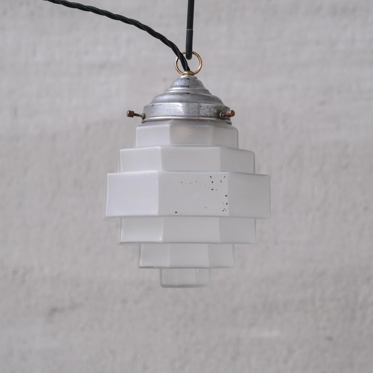 A small, stylish opaque stepped glass pendant light. 

France, c1950. 

Lovely graduated form. 

No rose was retained or chain, however they are easy to source online. 

Good vintage condtion, re-wired and PAT tested.

Location: Belgium Gallery.