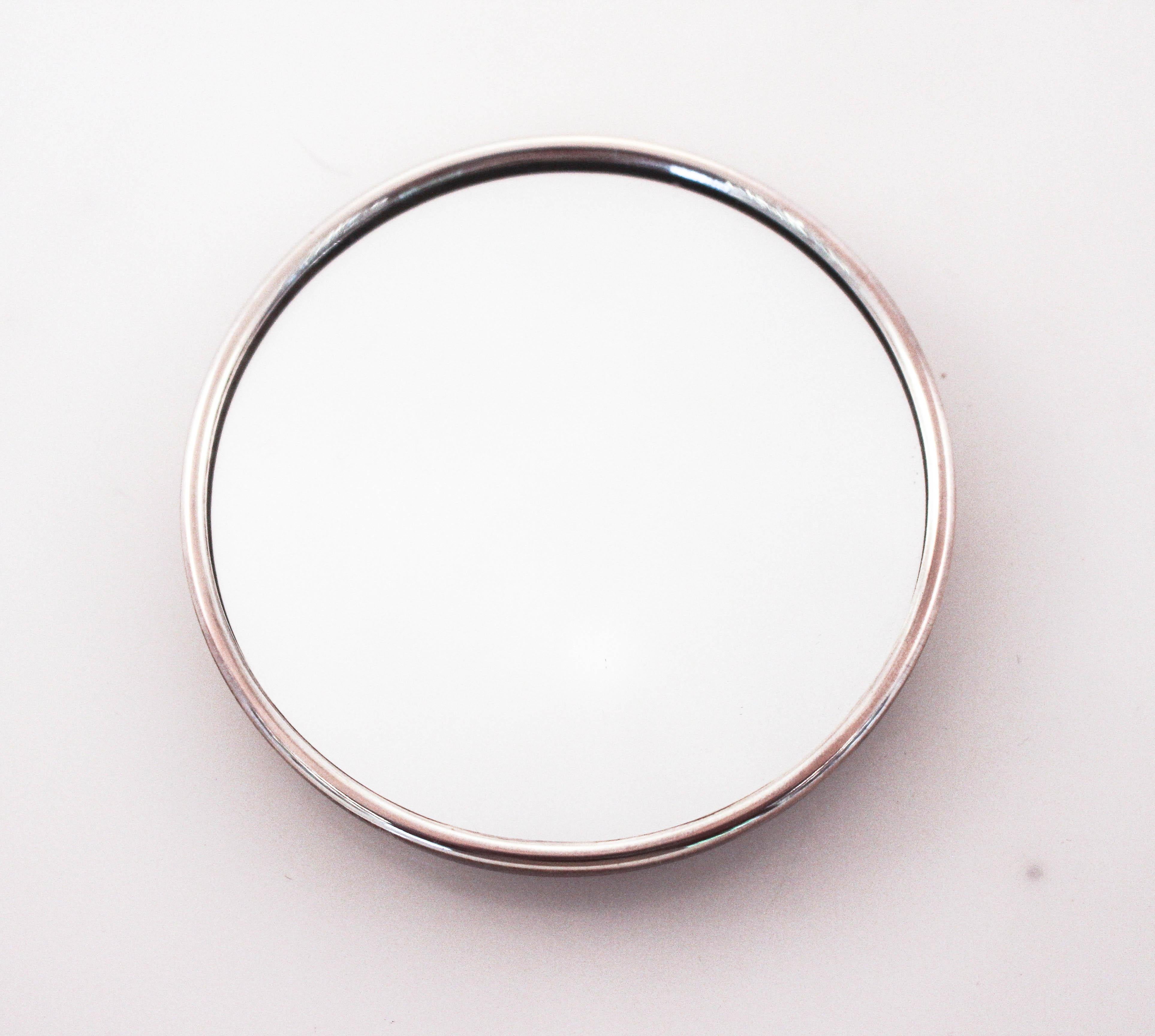 We are offering a brand new sterling silver compact mirror by Lunt Silversmiths. On side is sterling silver while the reverse side is a mirror. The silver has a pattern around the rim, and in the center room for a monogram. The original cloth sack