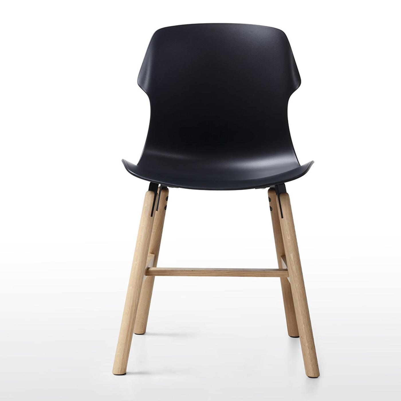 This modern, versatile design is offered in a wide range of colors and materials to be used in different interior styles. The contoured and ergonomic seat (45 cm height) is made of black polypropylene, glossy on the back and matte in the front, and