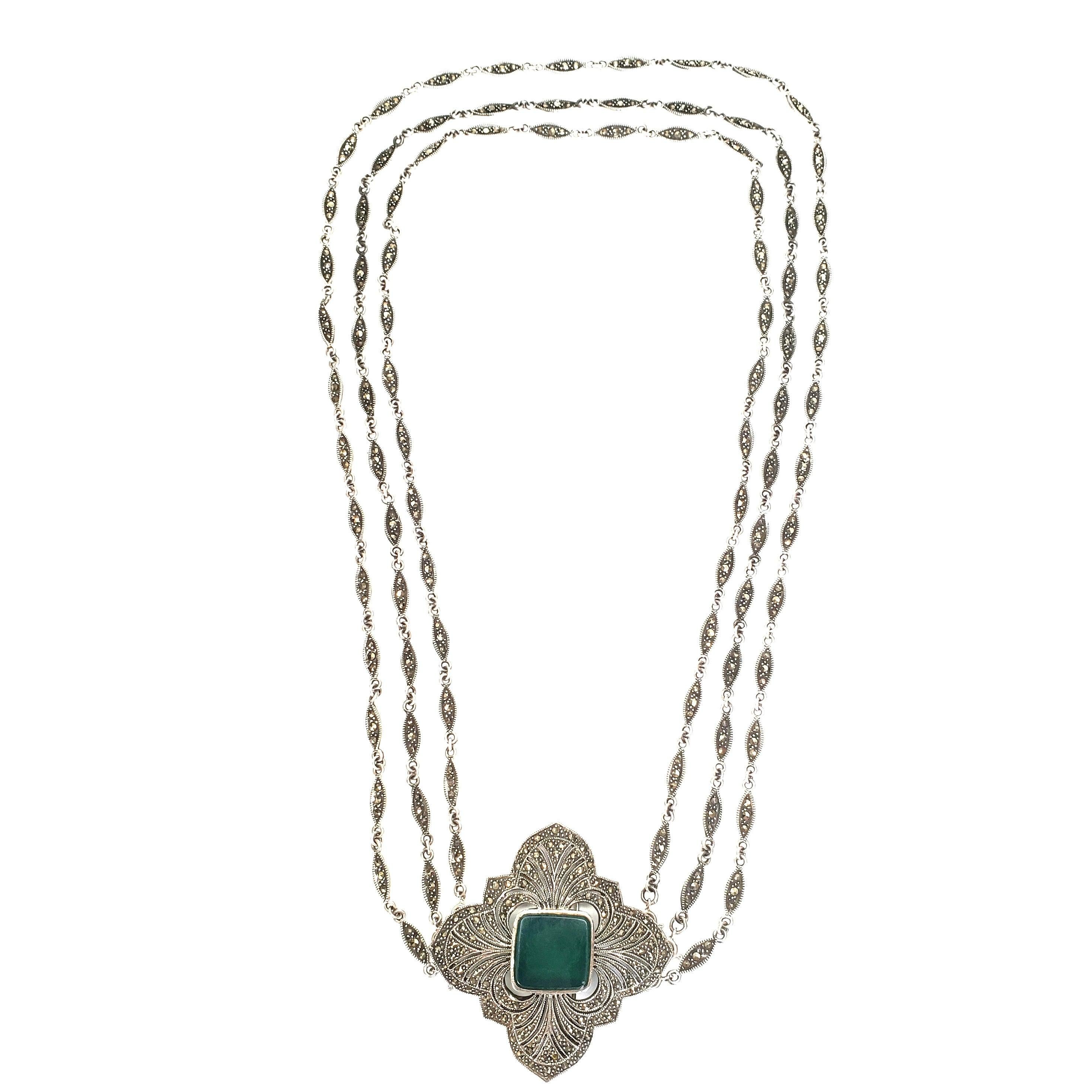 Vintage sterling silver three strand necklace with chrysoprase and marcasite pendant / pin.

Large and ornate marcasite encrusted pendant, that can also be worn as a pin, features a large square chrysoprase stone. Three detachable marcasite