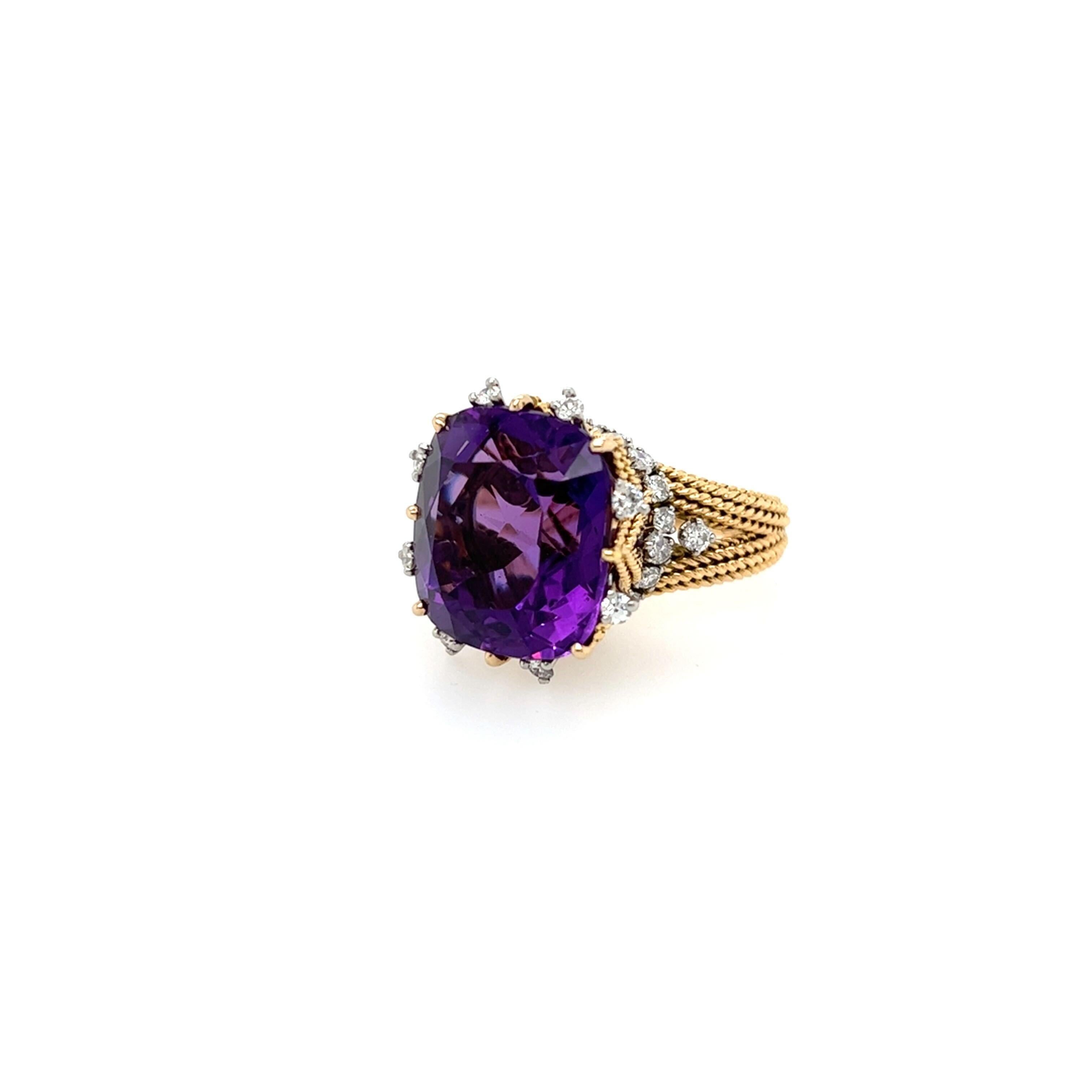An 18 karat yellow gold, platinum, amethyst and diamond ring, Sterle.  Centering a cushion cut amethyst measuring approximately 16.71 x 15.97 mm. in an elevated crown form setting of ropework enhanced with approximately twenty eight (28) platinum