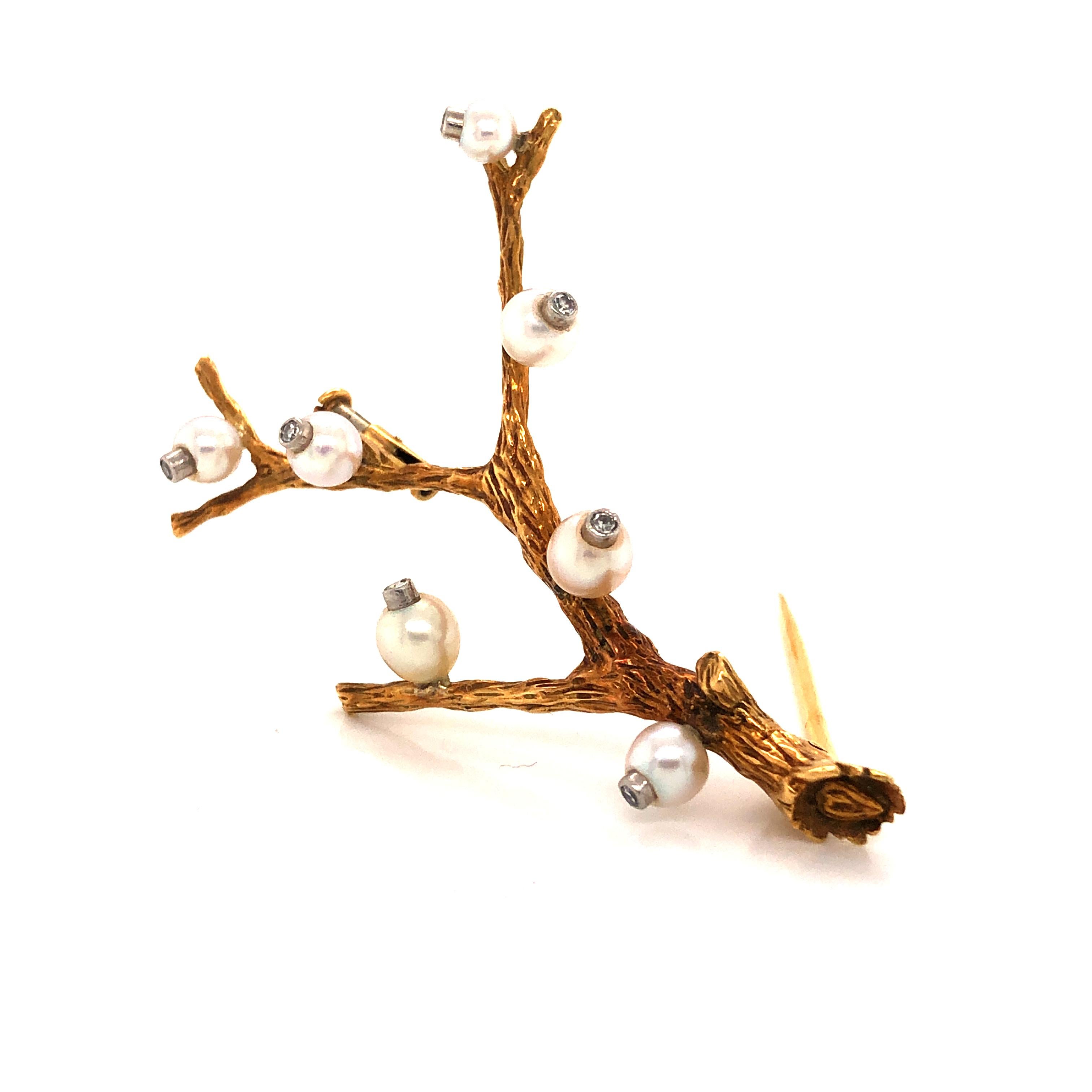 Gorgeous design from famed designer Pierre Sterle. This vintage brooch is crafted in 18k yellow gold.  The brooch shows exquisite detail as it depicts a branch set with natural pearls and diamonds. The detail on the branch is phenomenal as the tree
