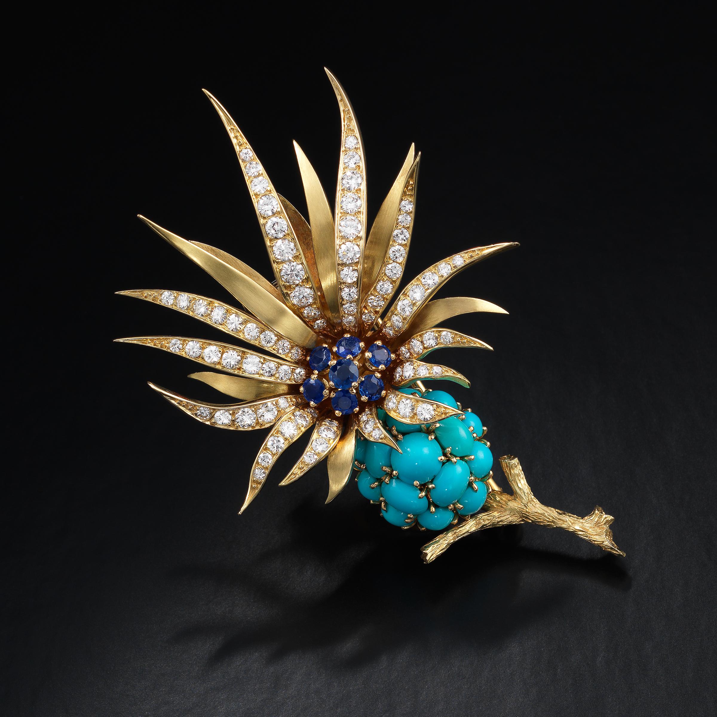 Spectacular and highly collectible 1950s brooch by Pierre Sterlé designed as flower in full bloom and featuring round blue sapphires, cabochon turquoise and round brilliant-cut diamonds, all set in 18 karat yellow gold. The brooch showcases many of
