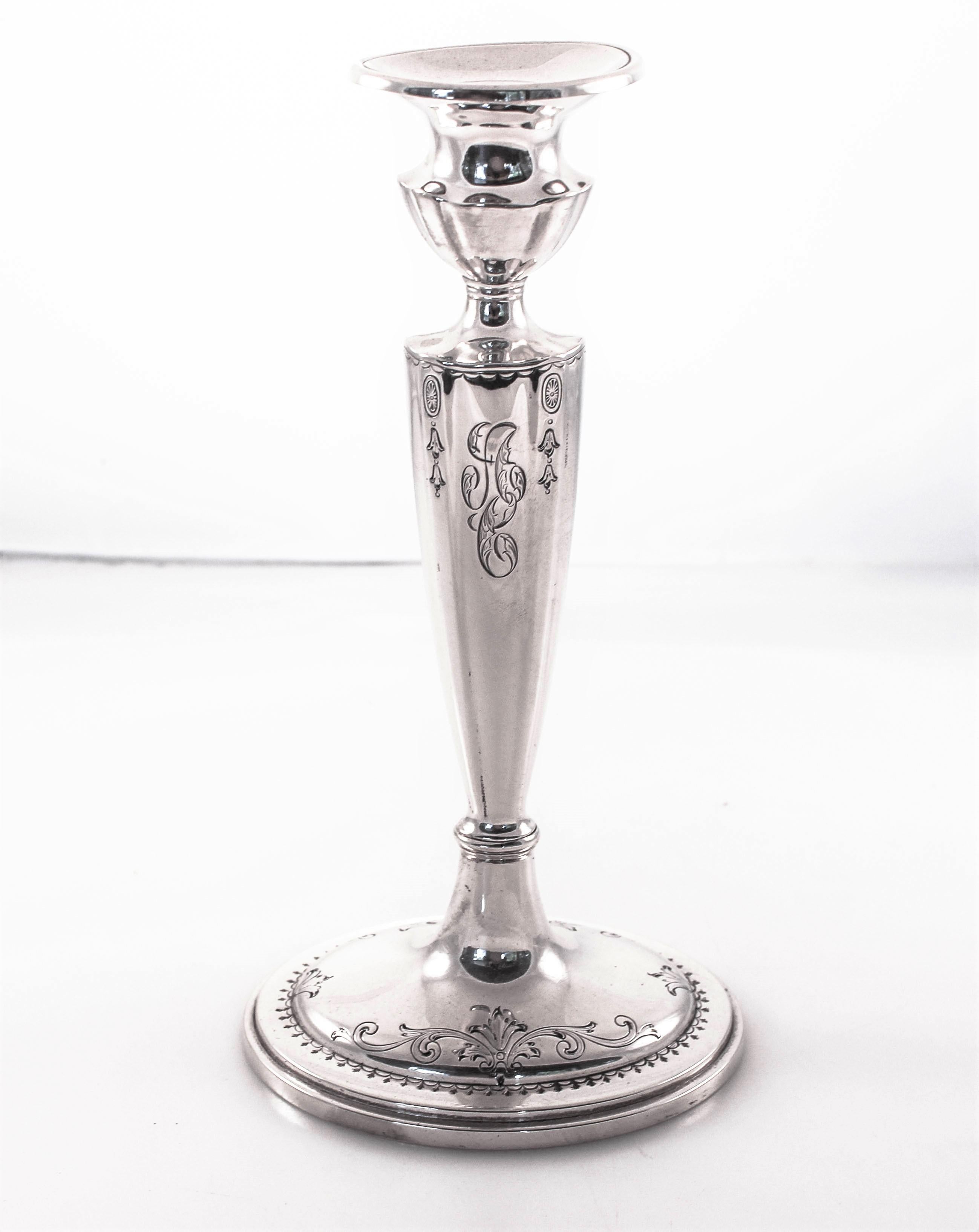 We are excited to offer this pair of sterling silver candlesticks dated 1915 by Gorham Silver Co, Providence Rhode Island. They have pretty etching around the base as well as top near the neck. They have an oval base and a tapered body. Gorham