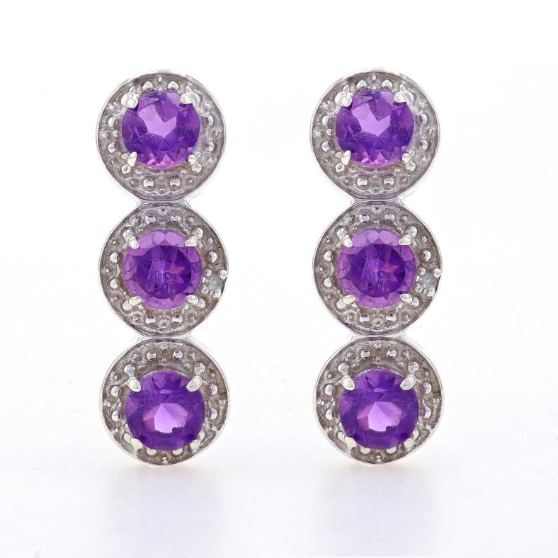 Metal Content: Sterling Silver

Stone Information
Natural Amethysts
Carat(s): 1.80ctw
Cut: Round
Color: Purple

Natural Diamonds
Cut: Single
Stone Note: (two small accents)

Total Carats: 1.80ctw

Style: Three-Stone with Accents Curved
