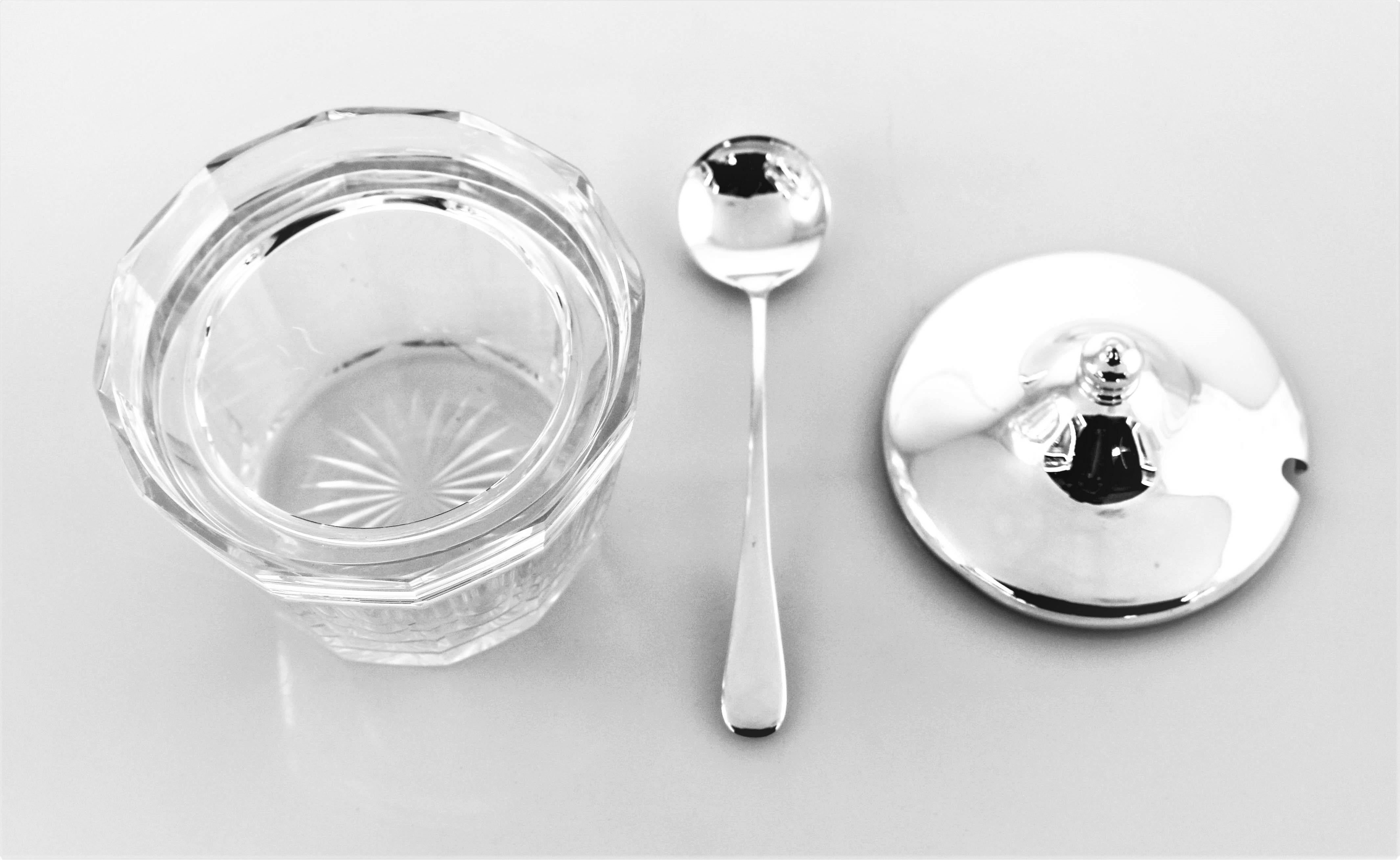 A sterling lid and spoon with a lovely crystal jar. The jar has a starburst on the bottom and is paneled around the side. The lid and spoon are clean and sleek and are original to the set. Great for jams, honey, mustard or any other condiments.