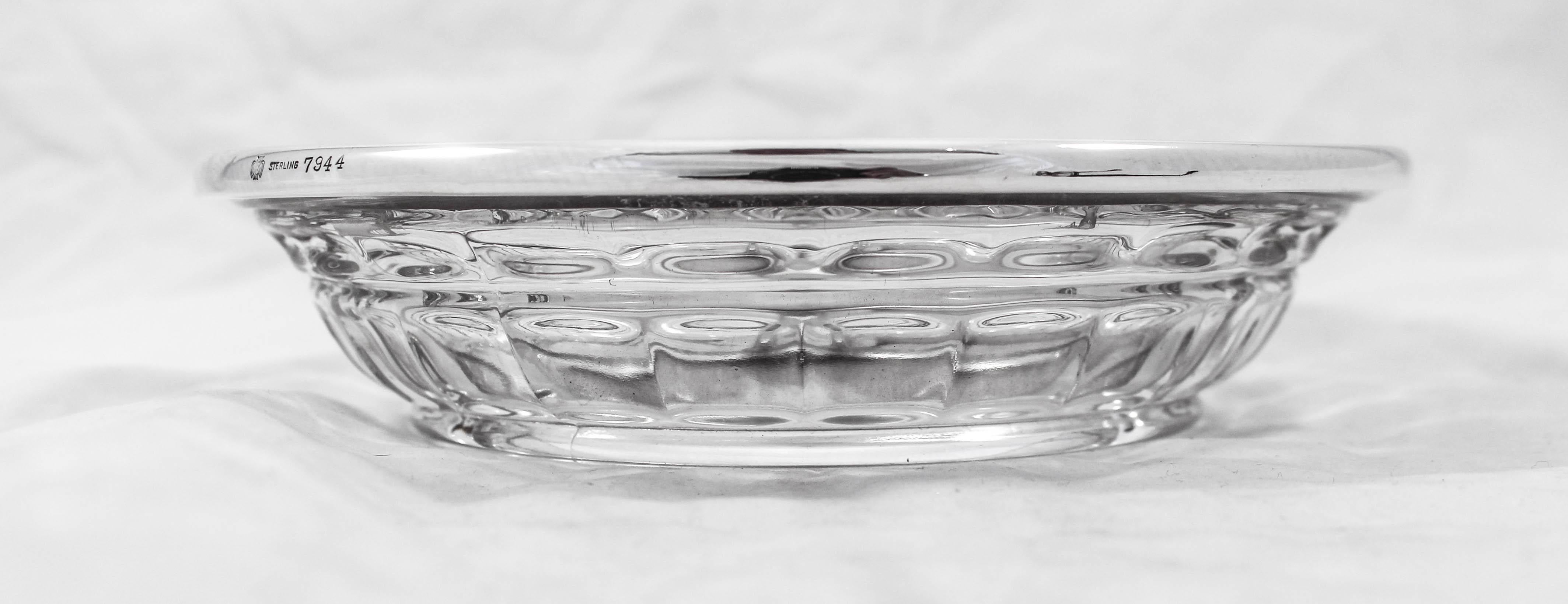 We are offering this sterling silver and crystal sectional. It has a sterling rim with a simple motif around the edge. The crystal has a symmetrical pattern with indentations. The center is divided into three equal sections. Fill it with nuts and