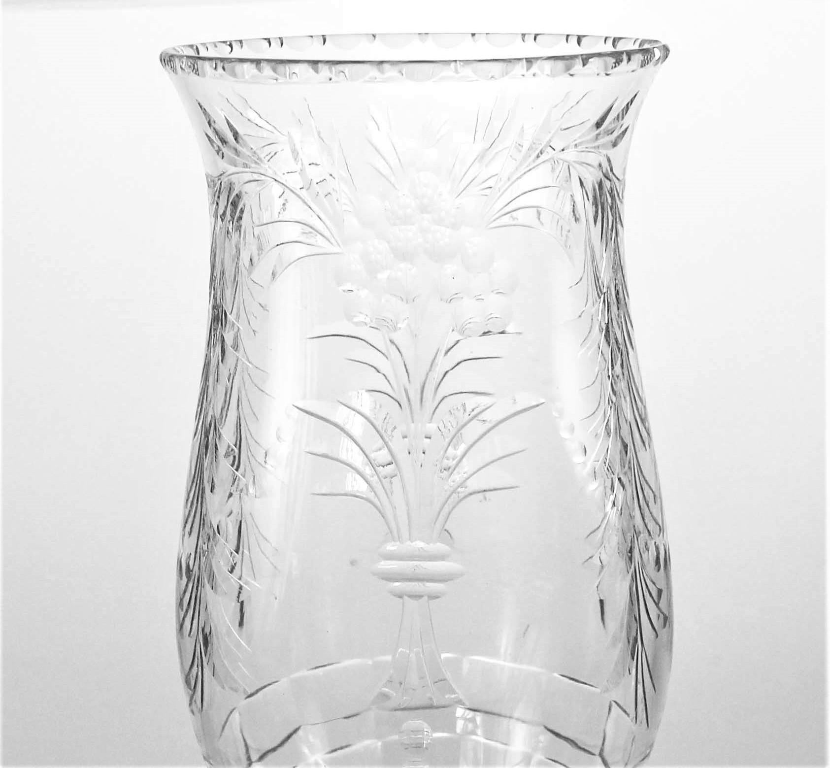 A fine mix between old-world elegance and modern chic. This vase has a sterling silver vase that has “steps”; a gradual raise in the silver. The crystal is a combination of cut and beveled crystal. There is an indented pattern running along the