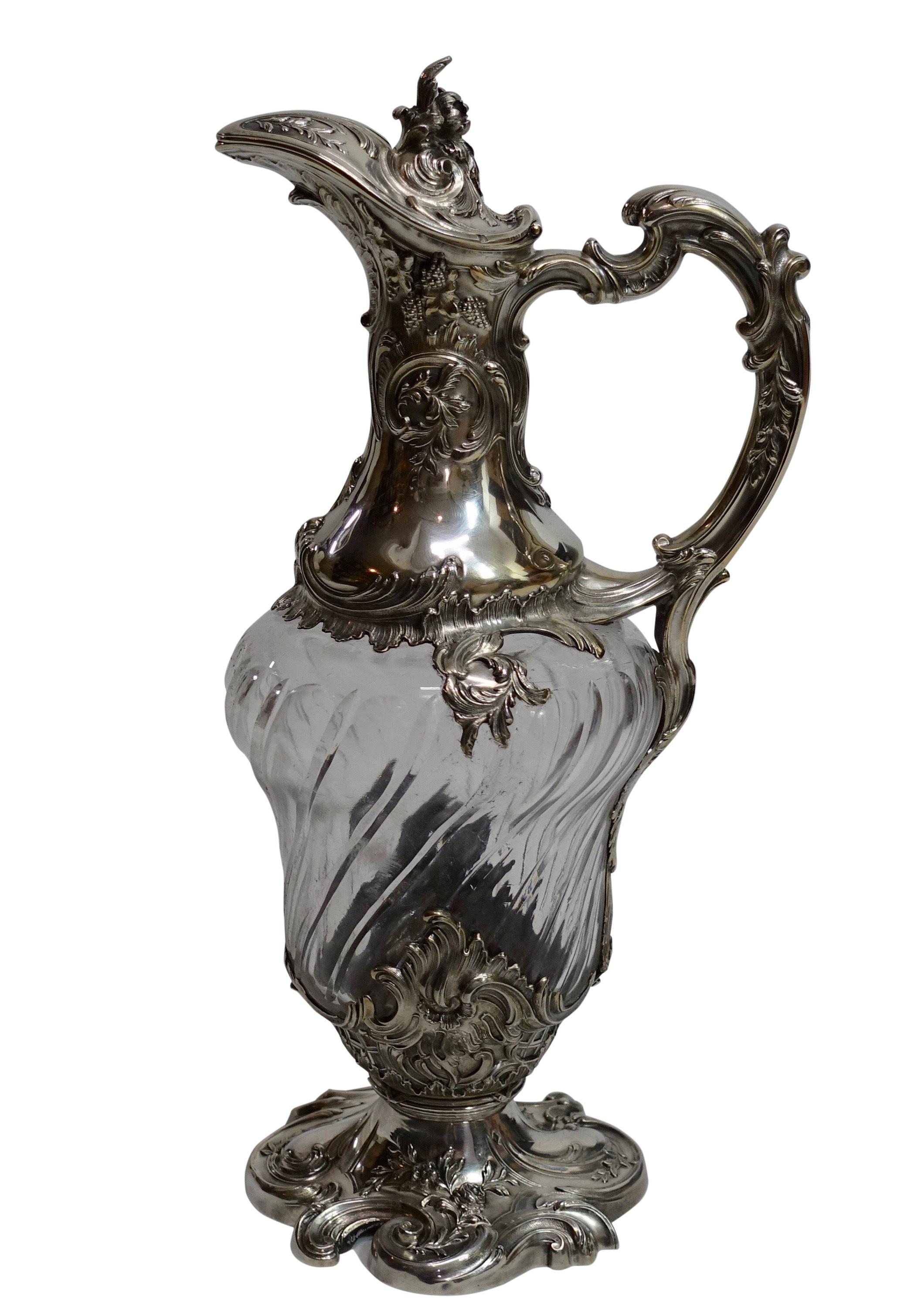 A cut glass claret pitcher with ornate sterling mounts in the Louis XVI style.