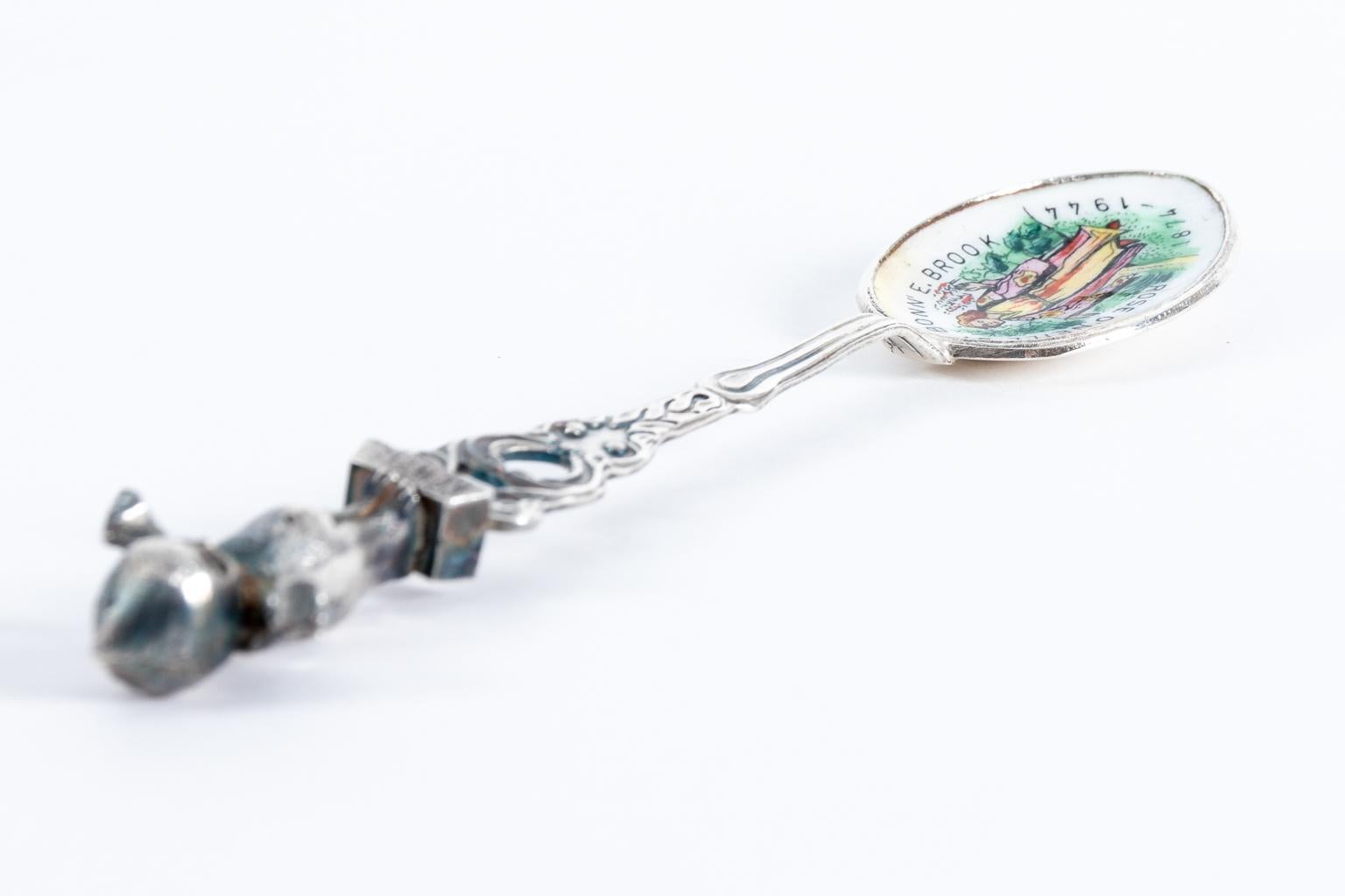 Rose O'Neill sterling and enamel spoon depicts a three dimensional kewpie on top, circa 1930s. This vintage spoon has a kewpie finial and an enameled bowl. The bowl reads Rose O'Neill 1874-1944 Bonn'E.Brook. It is marked Sterling-Albert H. Cechsle