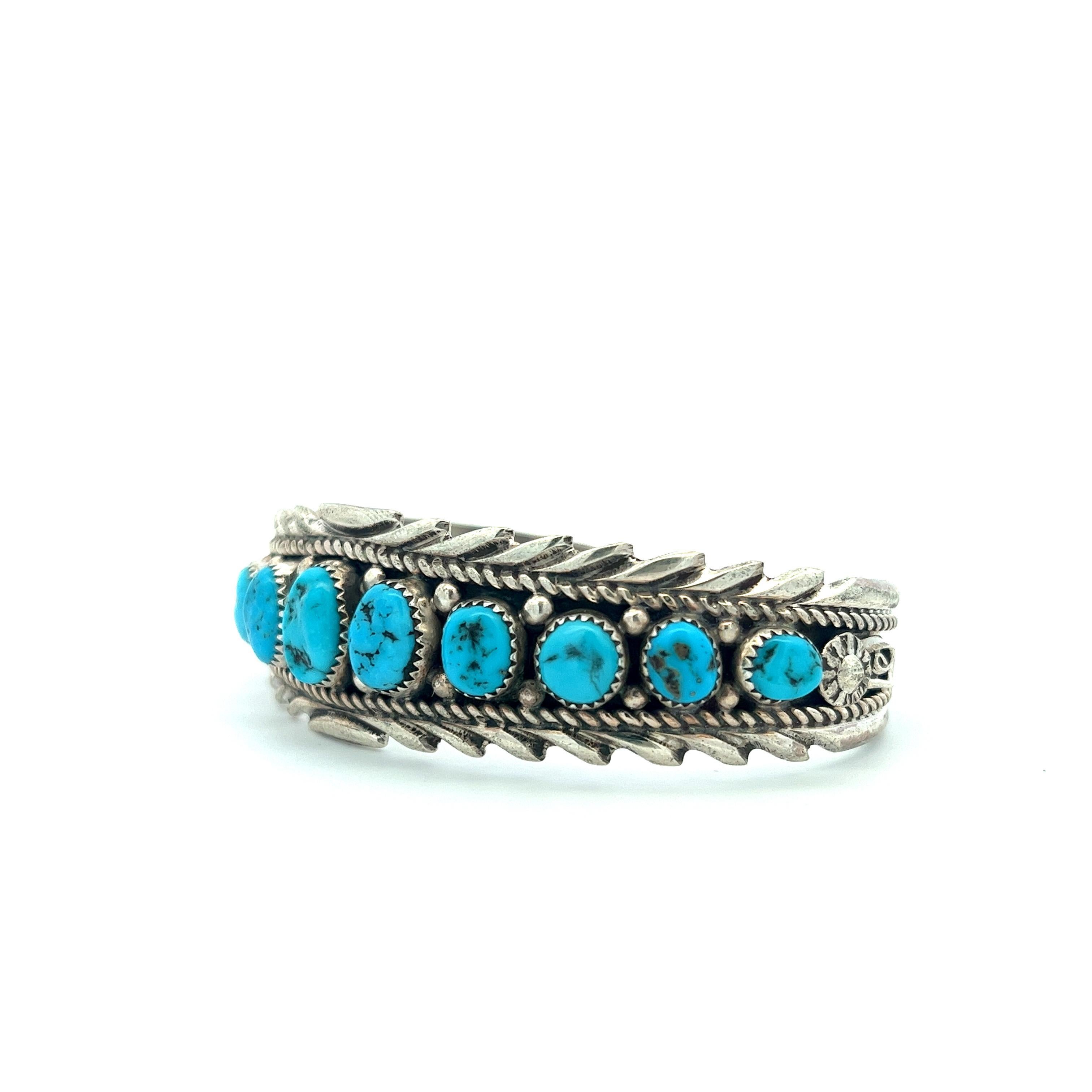 This timeless, heirloom-quality Navajo Kingman turquoise bracelet is a testament to vintage elegance and the remarkable craftsmanship of the renowned silversmith, Anthony Brown. The bracelet showcases eleven meticulously bezel-set, oval-shaped