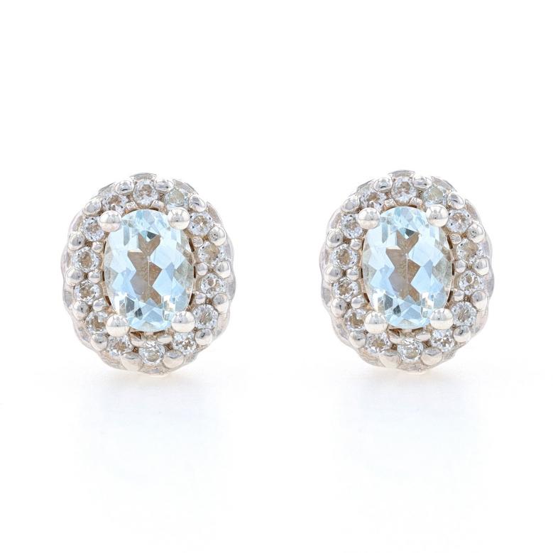 Metal Content: Sterling Silver

Stone Information

Natural Aquamarines
Treatment: Heating
Carat(s): 1.50ctw
Cut: Oval
Color: Blue

Natural White Topaz
Carat(s): .85ctw
Cut: Round

Total Carats: 2.35ctw

Style: Halo Stud
Fastening Type: Butterfly