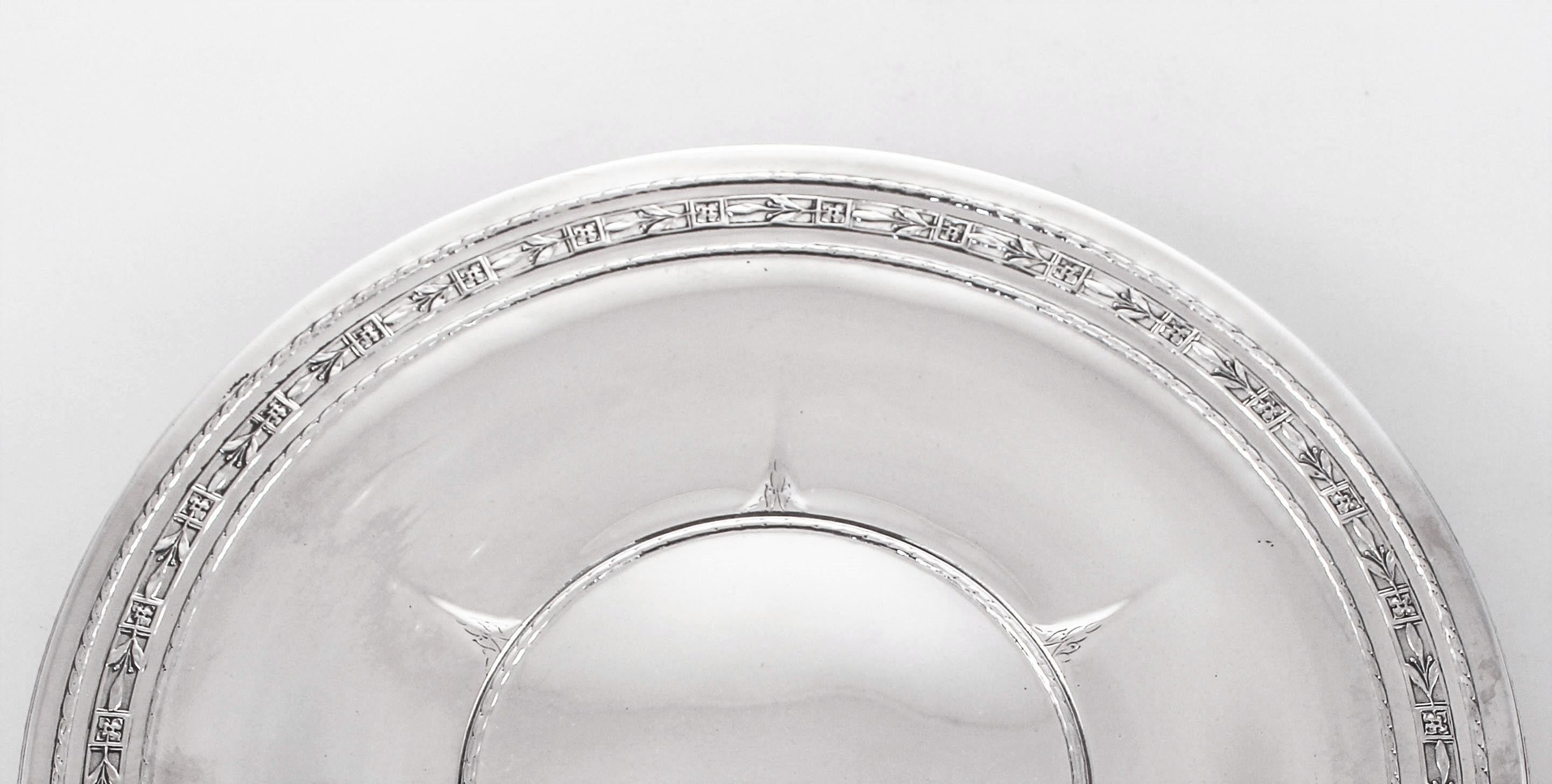 We are delighted to offer this sterling silver dish by William Durgin. It has a pretty border with a symmetrical design. It stands on a center pedestal - not weighted, that has the same symmetrical design. In the center of the tray there is a