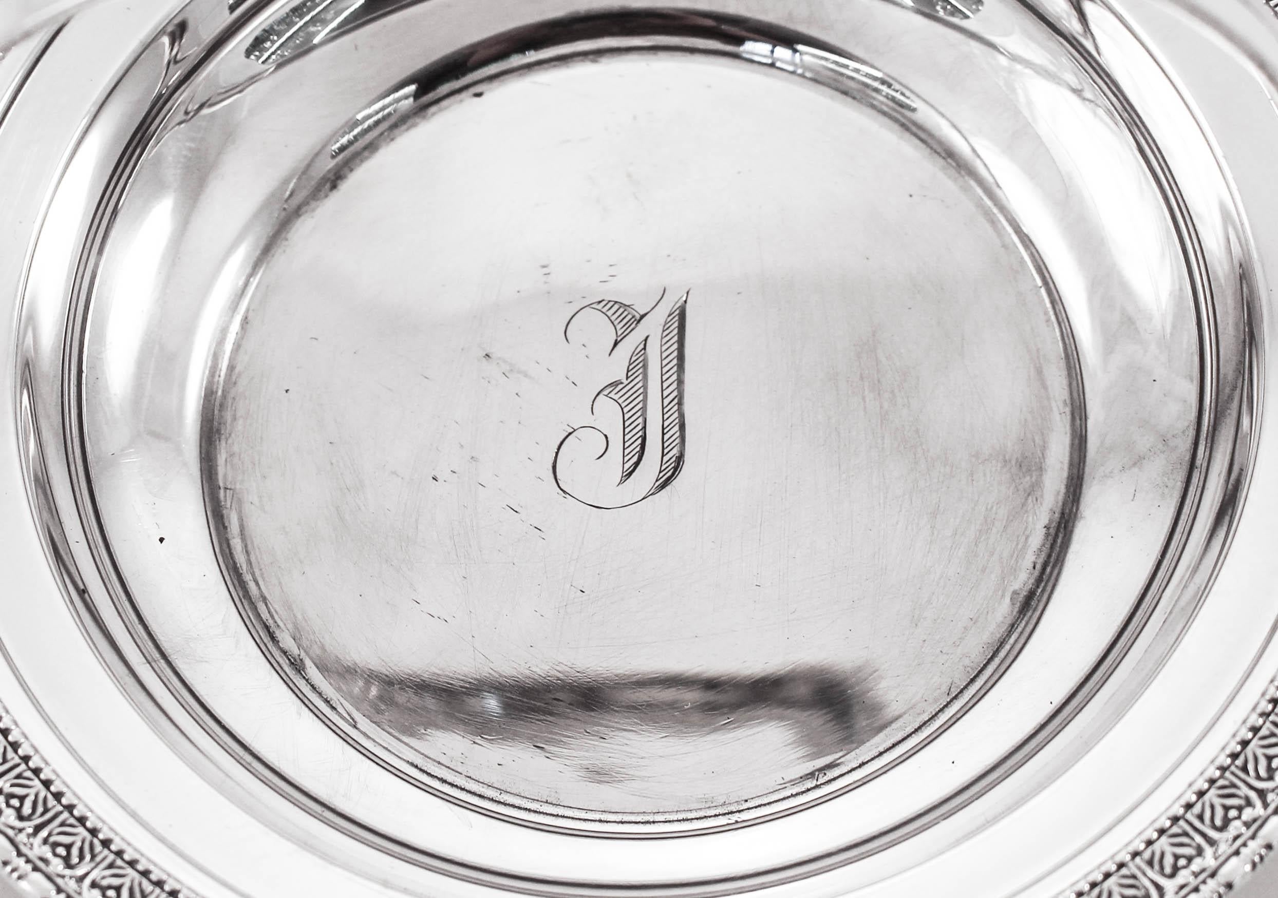 This adorable sterling silver basket is just precious! Perfect for candies or any other snack on your coffee table. A simple motif encircles the edge and a stationary handle for that extra touch. In the center there is a hand engraved Old English