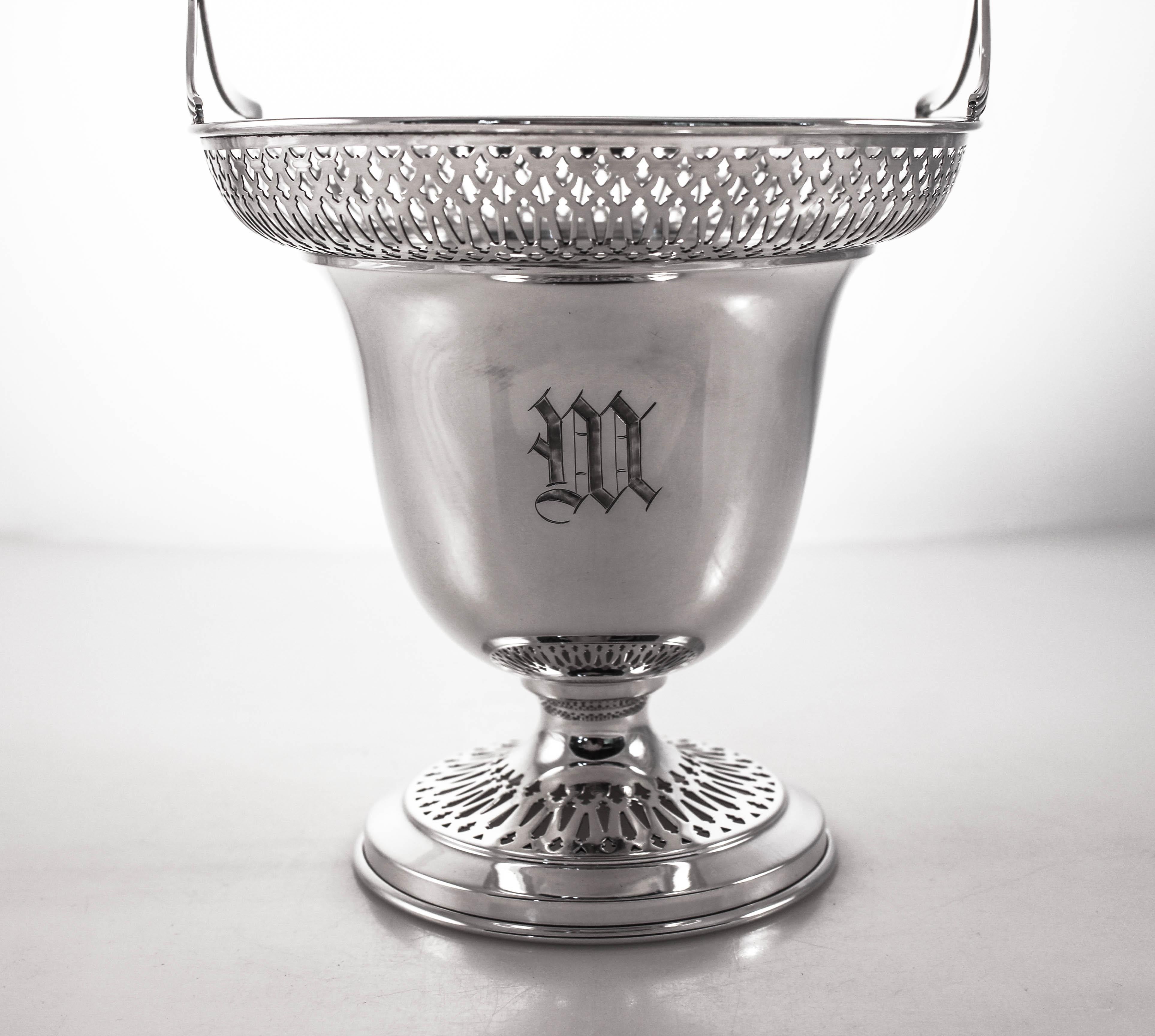 We are proud to offer this sterling silver basket by the Meriden Britannia Company of Meriden, CT. A lovely latticework pattern encircles there top as well as the base. Symmetrical and fluer de lis cutouts give it an open, airy feel. The handle is