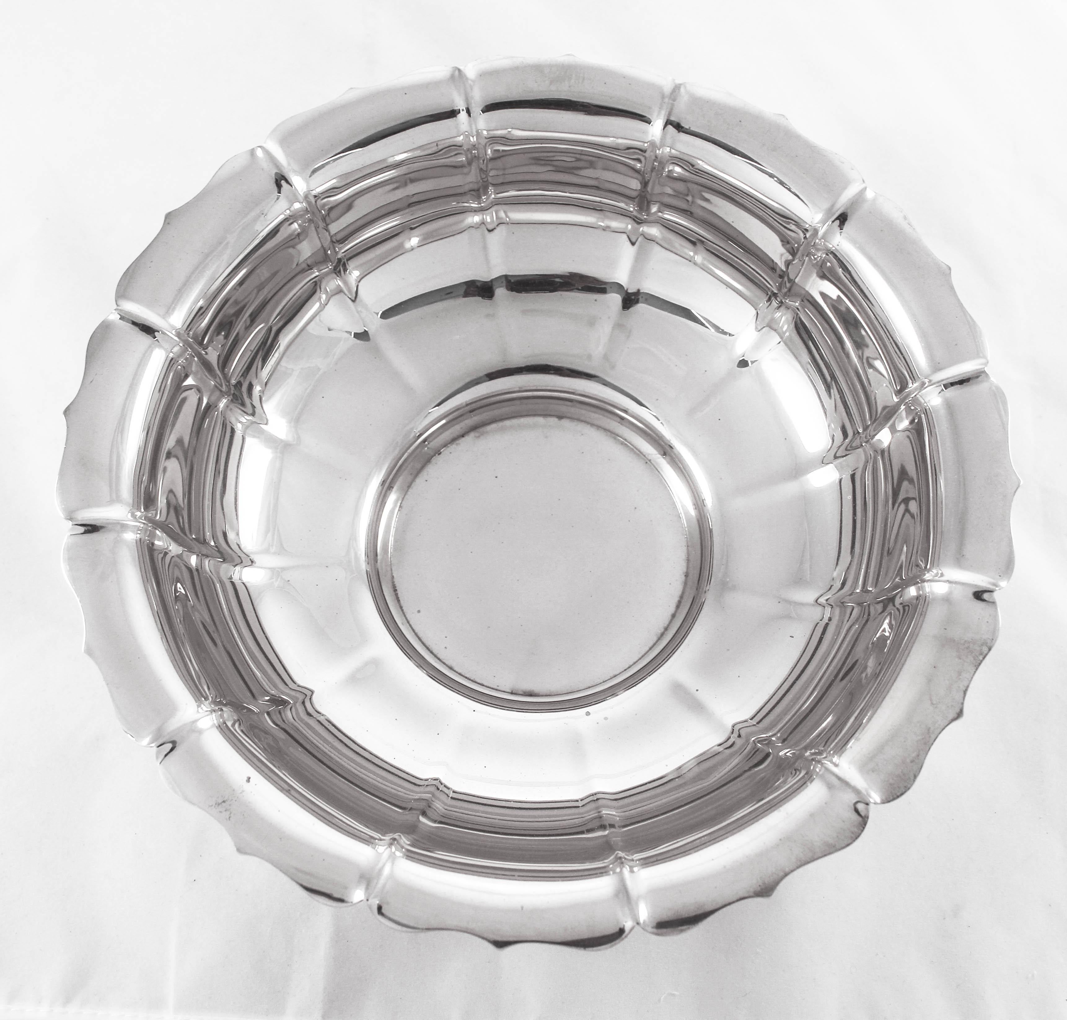 This sterling bowl has a scalloped edge and a modern sleek design. The bowl stands on a center pedestal, raising it off the surface. It’s a piece that can be used for just about anything; from hot food to cold fruit. It’s a practical size, and can