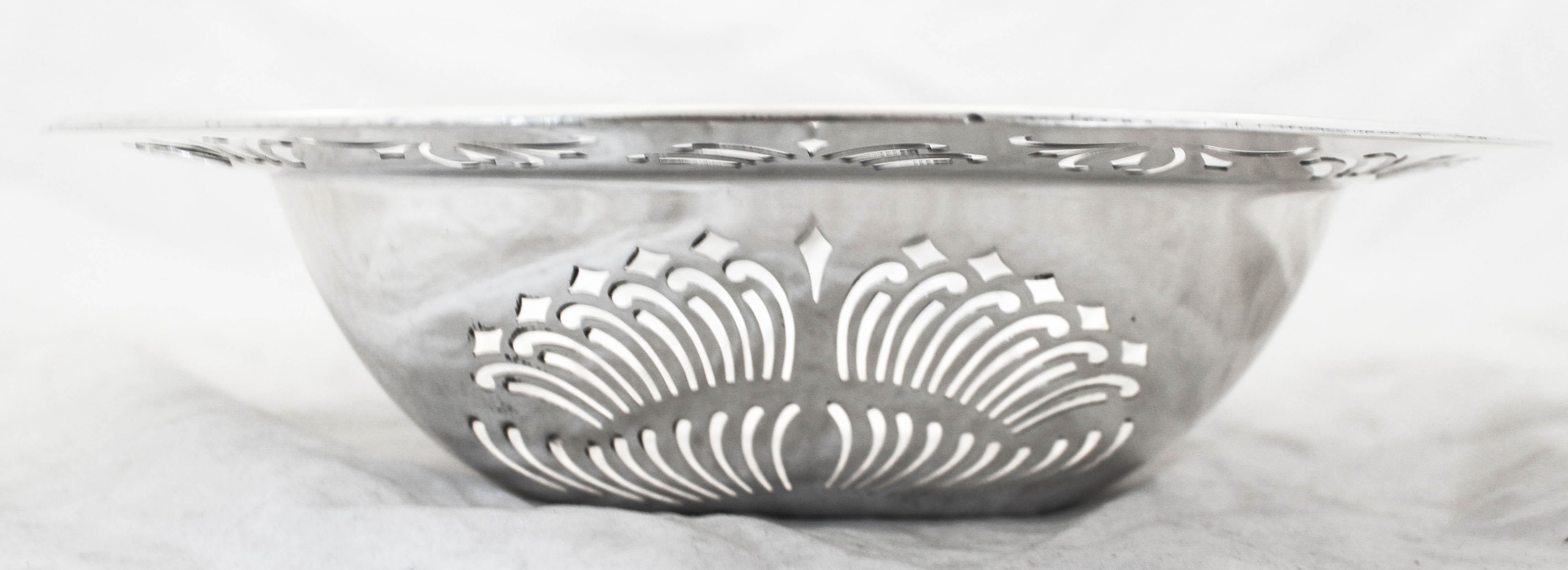 Being offered is a sterling silver bowl by Towle Silversmiths. A rather unusual shape and design, the piece is not like other bowls we’ve had and sold. The entire body and rim has a cutout design that gives it a lot of personality. Swirls and curves