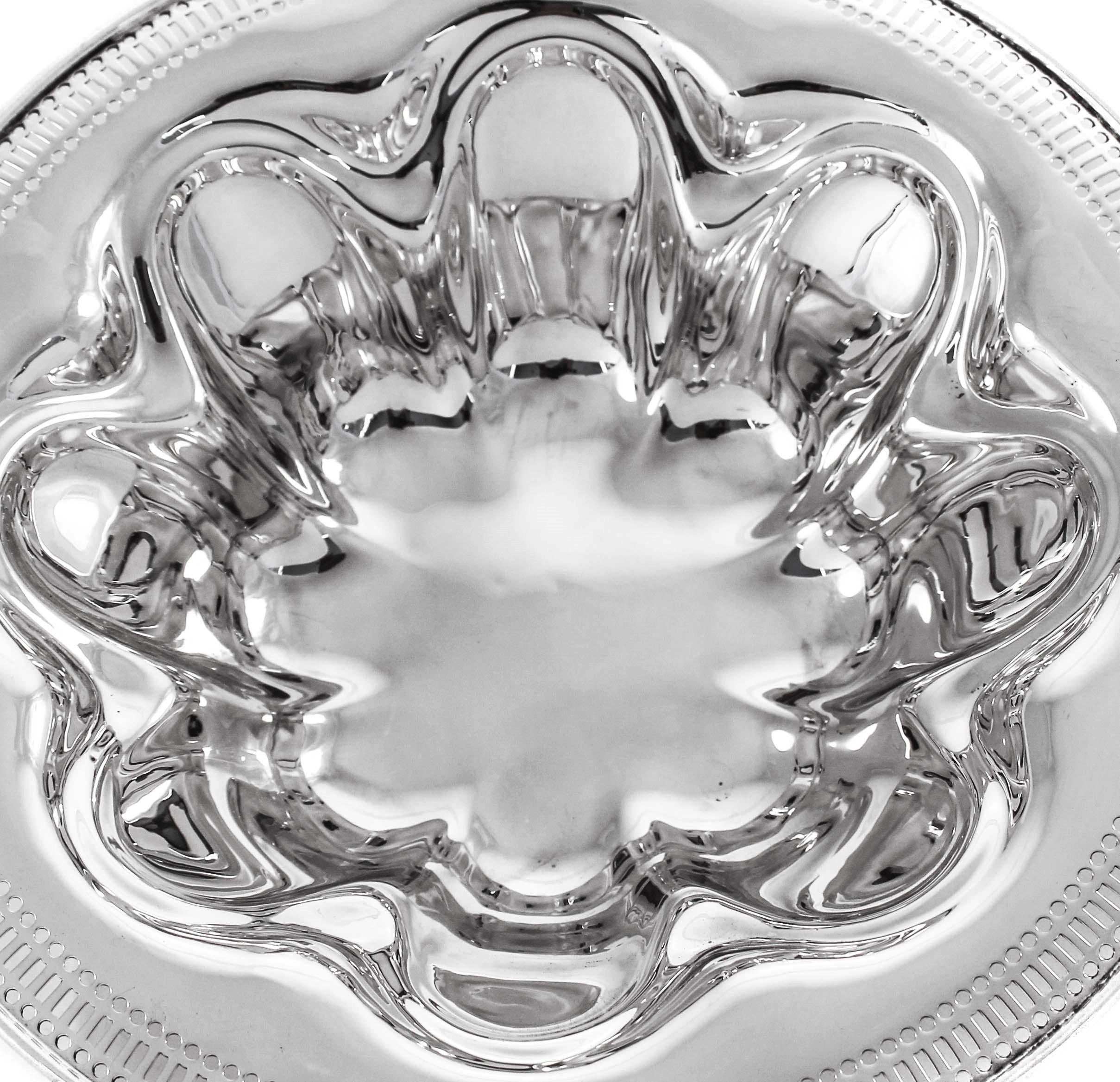 This bowl has an Art Deco style to it; the symmetrical cut-outs along the edge. On the inside eight indented shapes give the bowl another dimension of the Art Deco style.