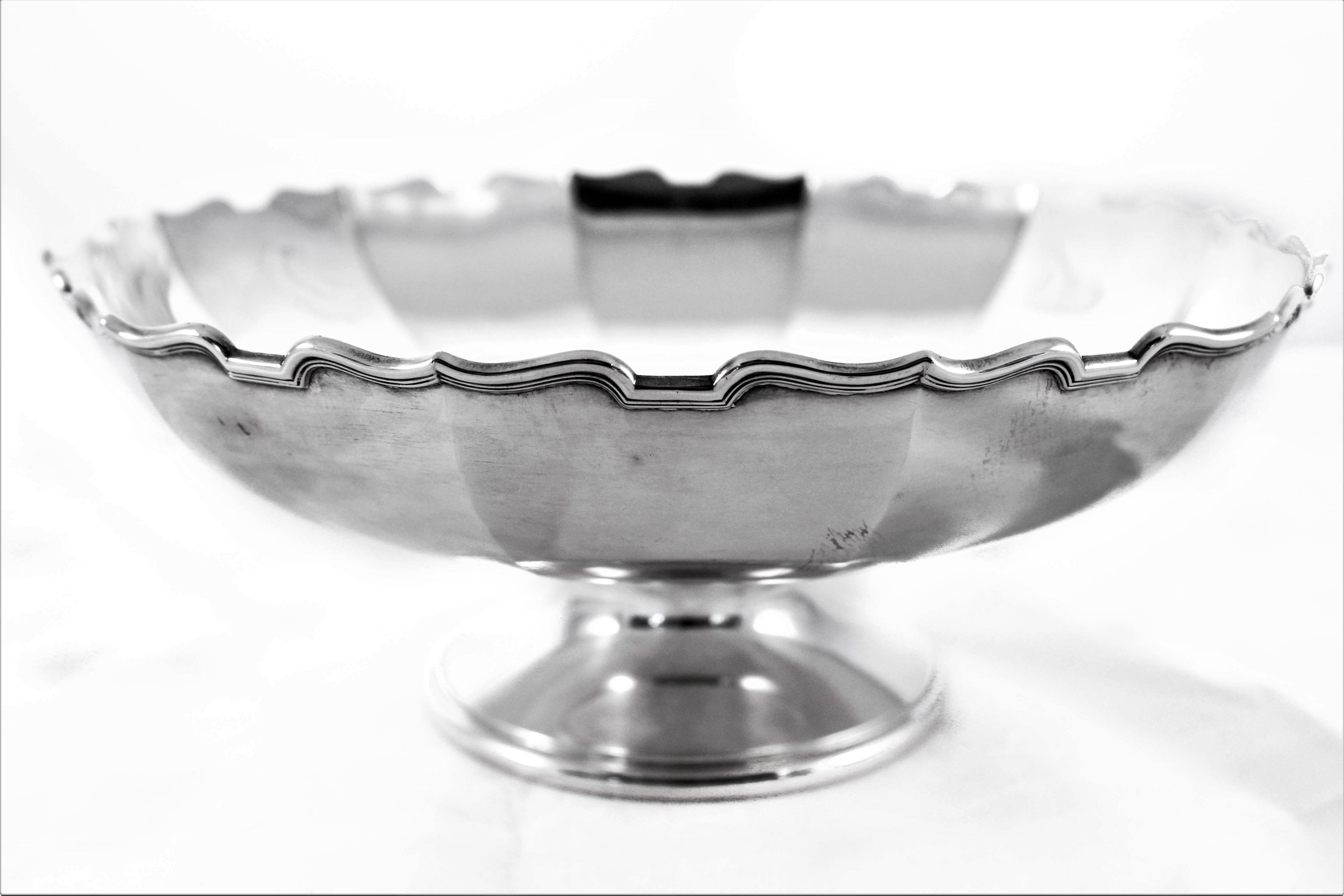 Proud to offer this regal sterling bowl on a pedestal (not weighted). It has a simple yet elegant style. A scalloped rim with a panel-like design around the body. The perfect size and height for the centre of a breakfast table, filled with apples or