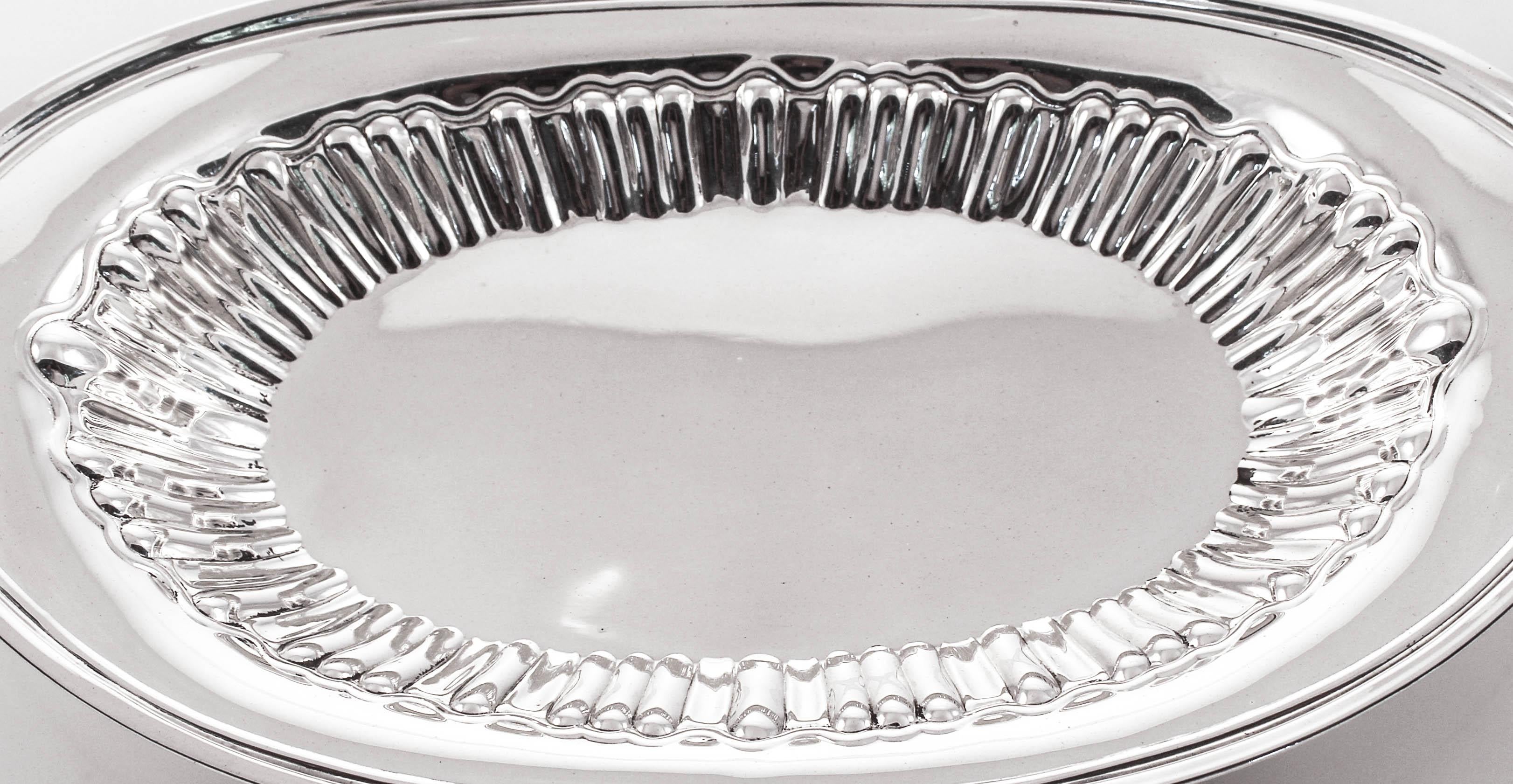 Being offered is a sterling silver breadbasket by the Amston Silver Company of Meriden, Connecticut. It has a sleek modern look with a scalloped interior. The perfect size for an intimate dinner and so practical for just about anything you want to