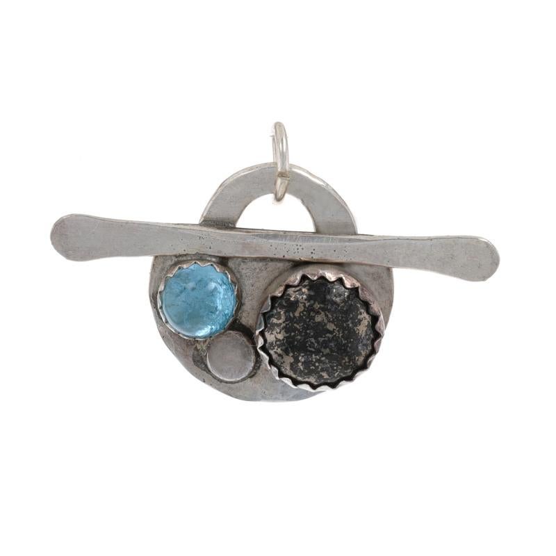 Metal Content: Sterling Silver

Stone Information

Natural Bronzite
Cut: Round Cabochon

Natural Blue Topaz
Treatment: Routinely Enhanced
Cut: Round Cabochon

Theme: Abstract
Features: Brushed & hammered finishes

Measurements

Tall (from stationary