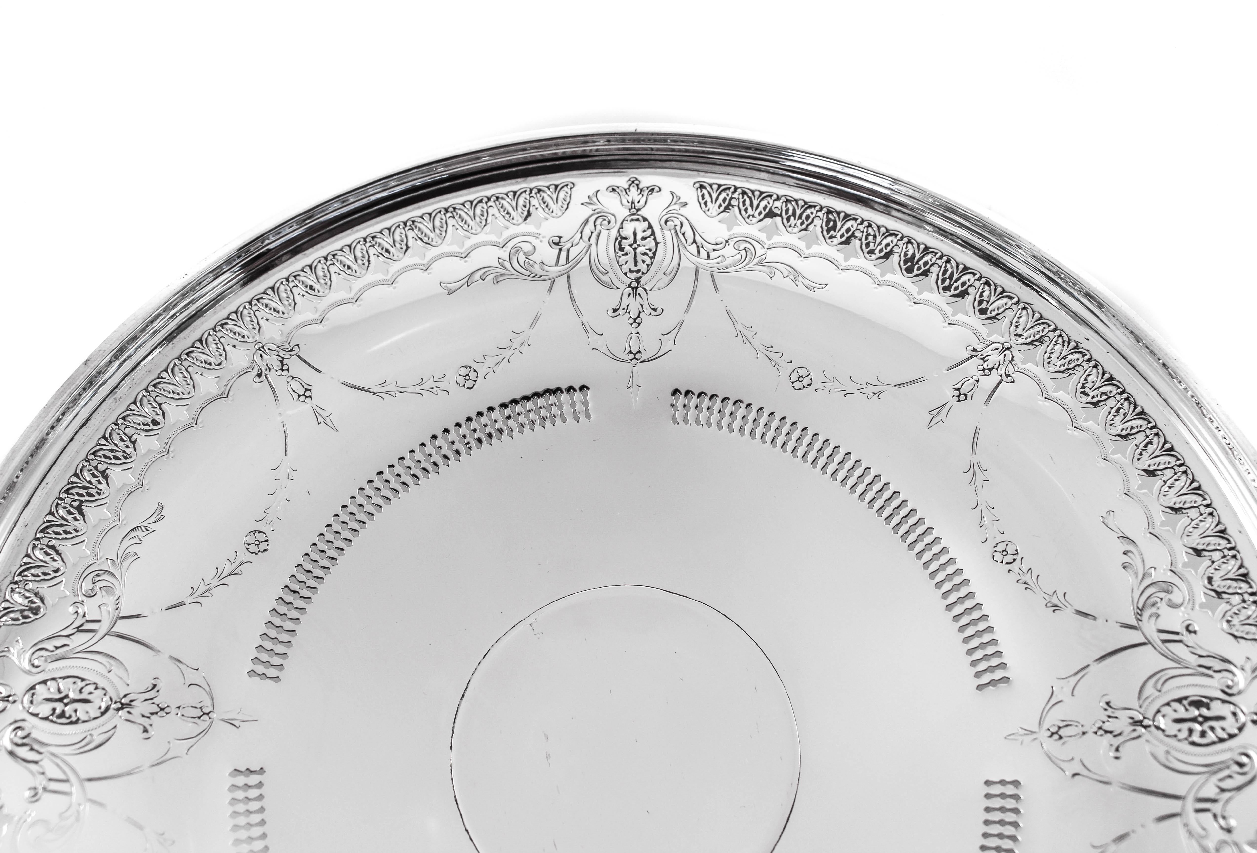 Old world elegance is yours for the taking in this beautiful sterling silver cake plate. Standing on a pedestal the rim has a slight lip to hold whatever is inside. Around the edge a cutout pattern with fleur de lis decorates the entire