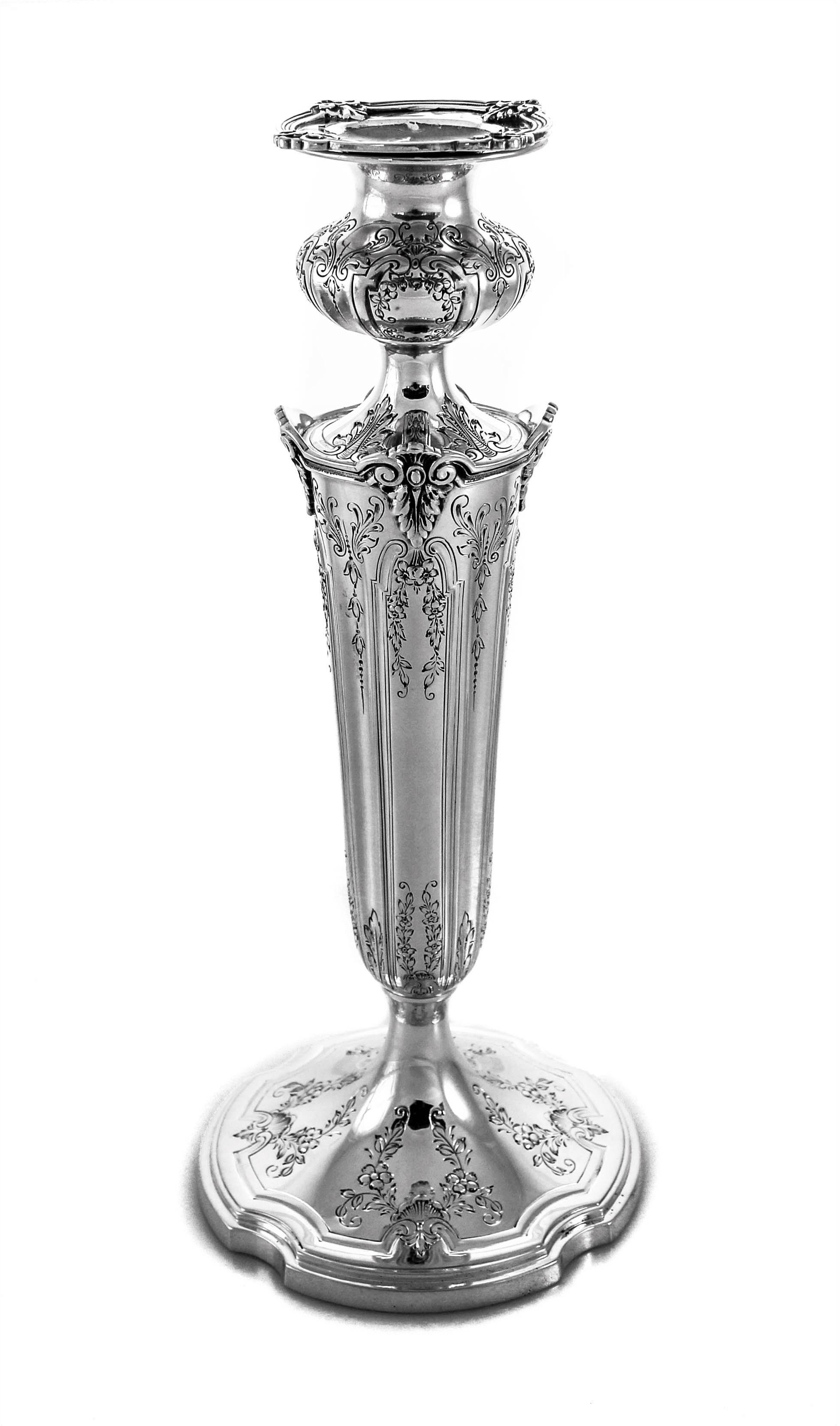 These sterling silver candlesticks have etched flowers and vines decorating the base and all around the top. Notice the scalloped base and the matching scalloped bobeche. Towards the top of the candlestick the silver juts out to form little corners.