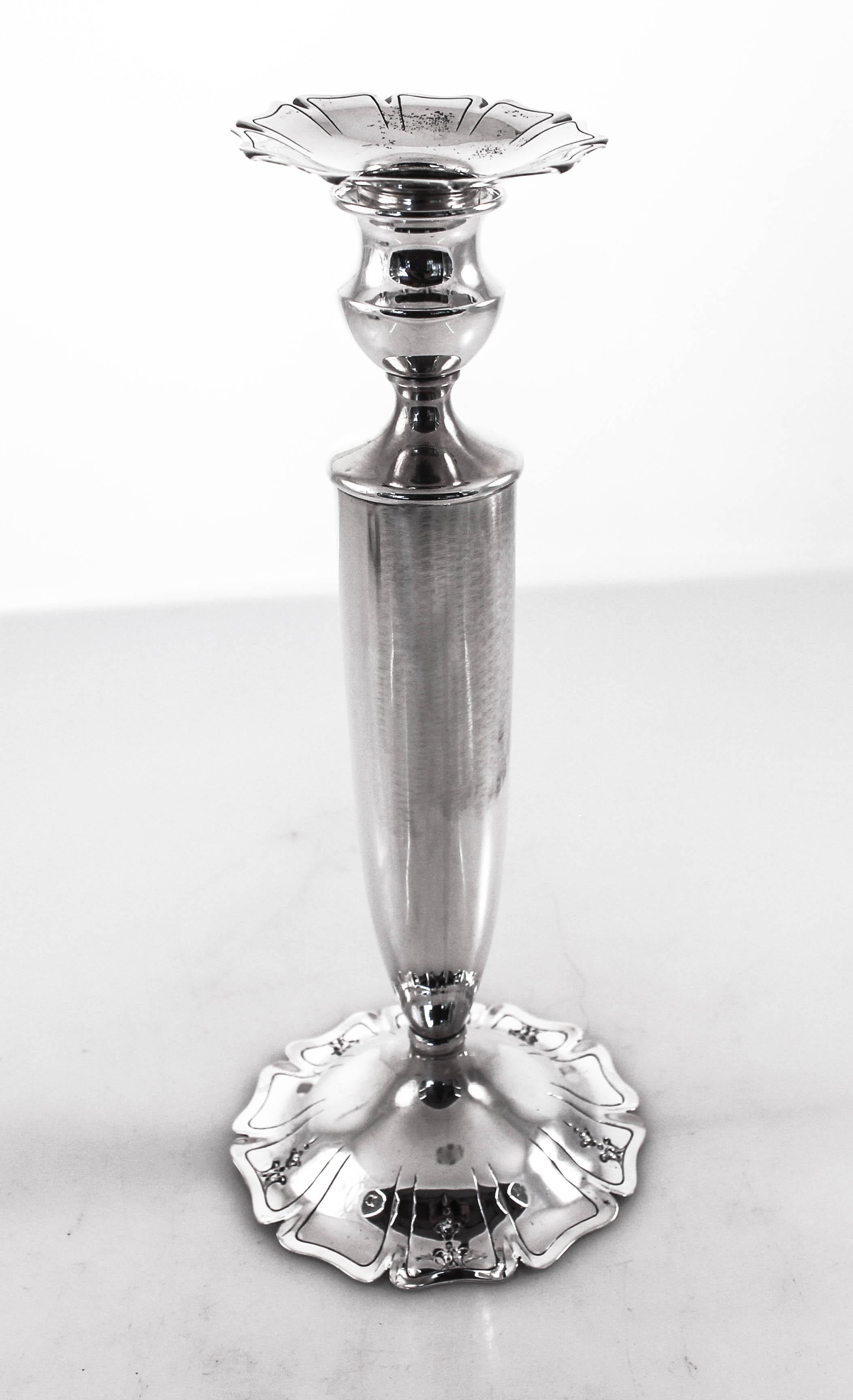 We are proud to offer these sterling silver candlesticks from the 1930s. They have a clean look with just the slightest touch of decoration, along the rim of the base and bobeche it is scalloped and etched. They are not weighted and have been