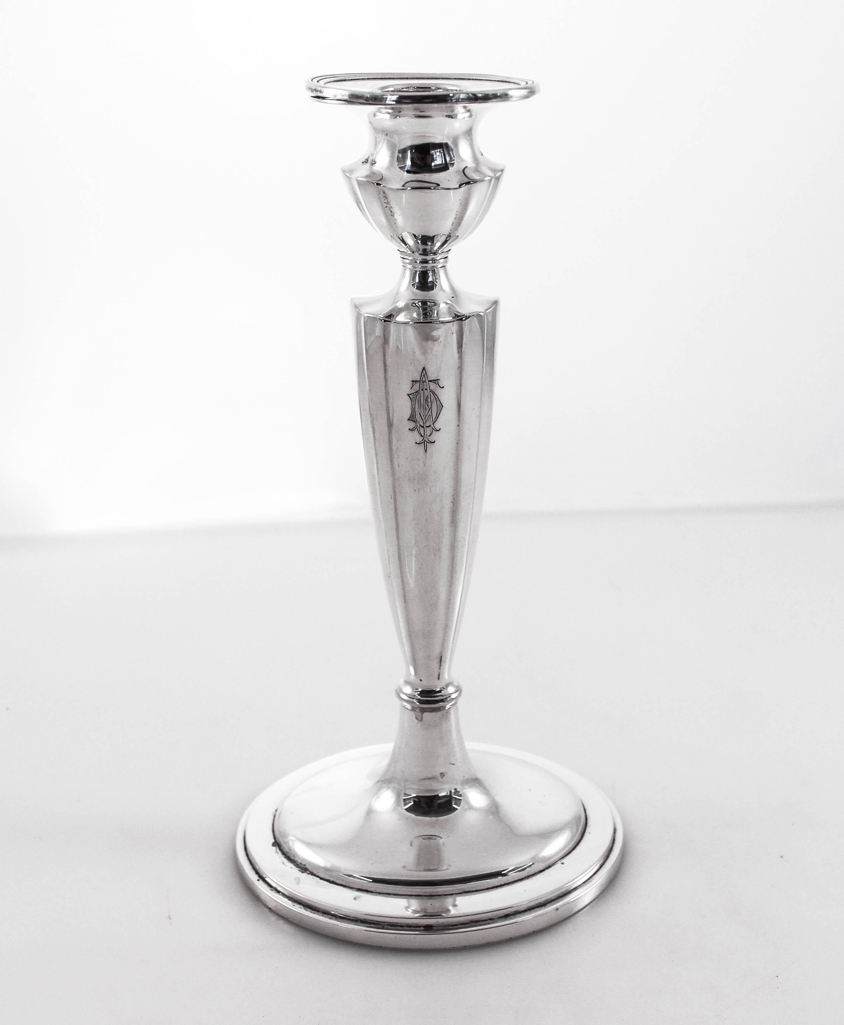 A pair of sterling silver candlesticks by Gorham Silver Company in the “Plymouth” pattern. A tapered body, an oval vase and a ribbed bobeche. Young, modern and functional.
