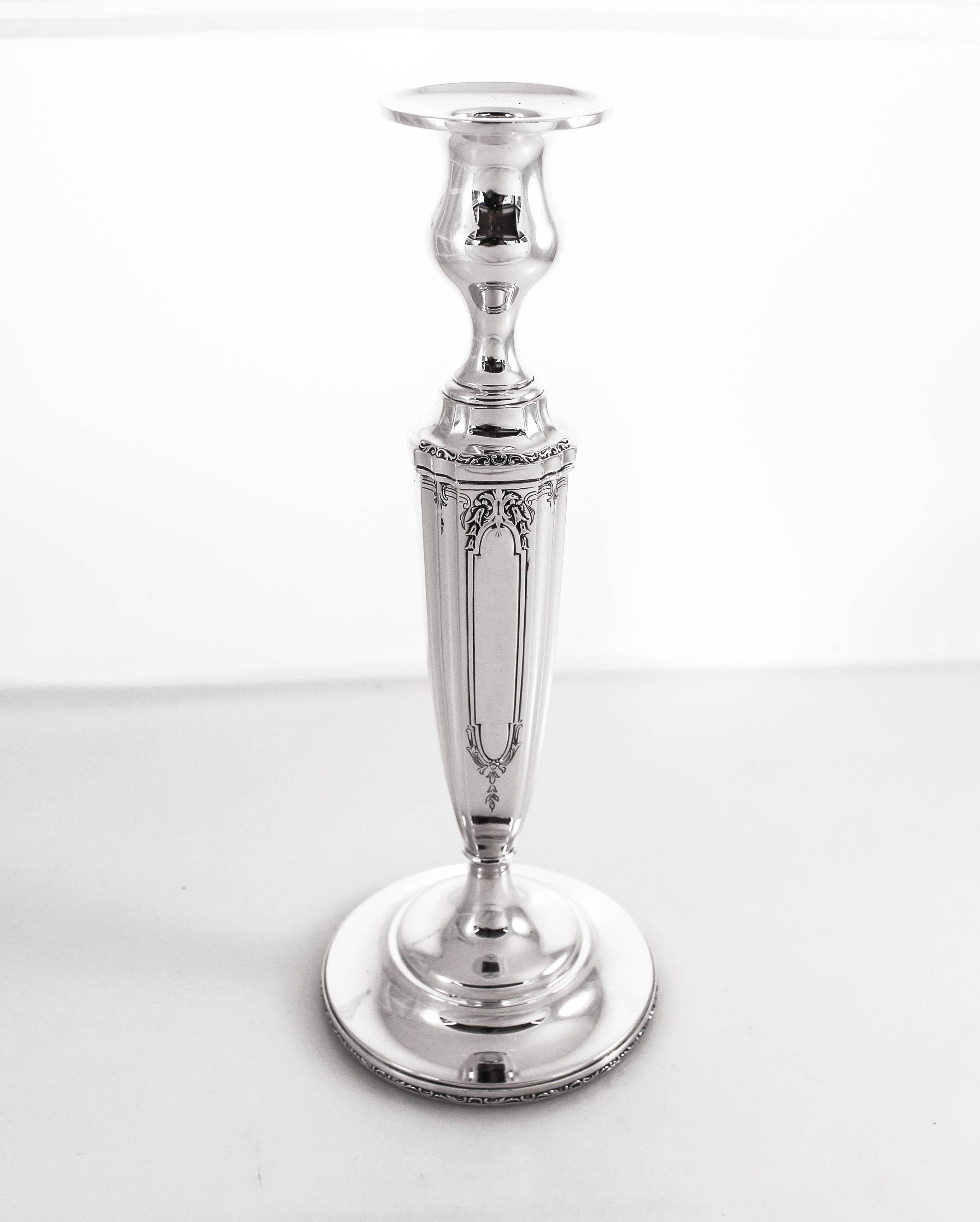 Offering a pair of sterling silver candlesticks by Wallace Silversmiths. They are not too ornate and not too plain; just a perfect mix between the two styles. Pretty etched work around the base and the top with a scalloped body. They are tapered and
