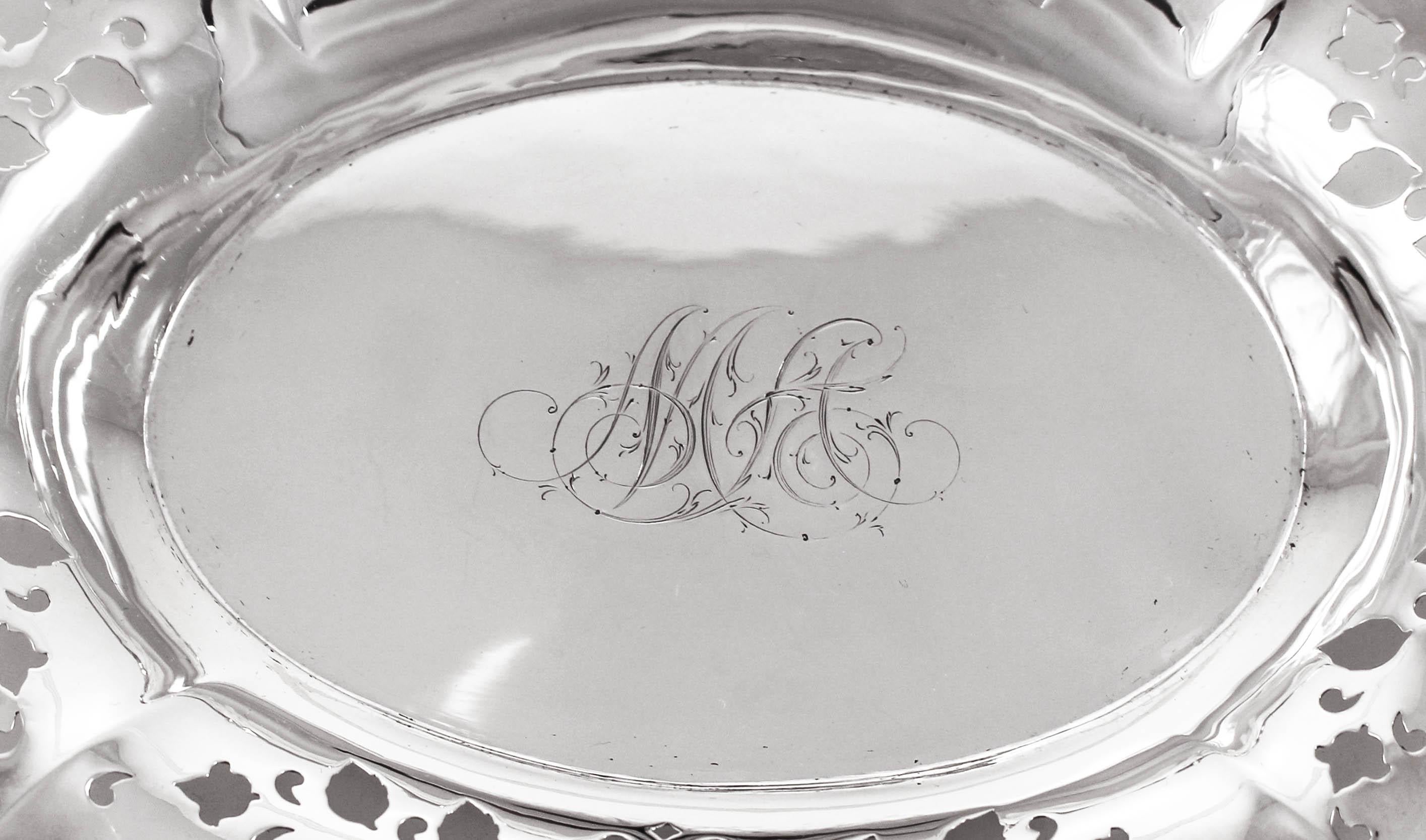 We are proud to offer this sterling silver dish by Wilcox and Eversten. It has a scalloped rim with cutouts around the border. Hearts, leaves and other shapes are cutout to give it an airy-look. In the center there is a hand engraved monogram. This