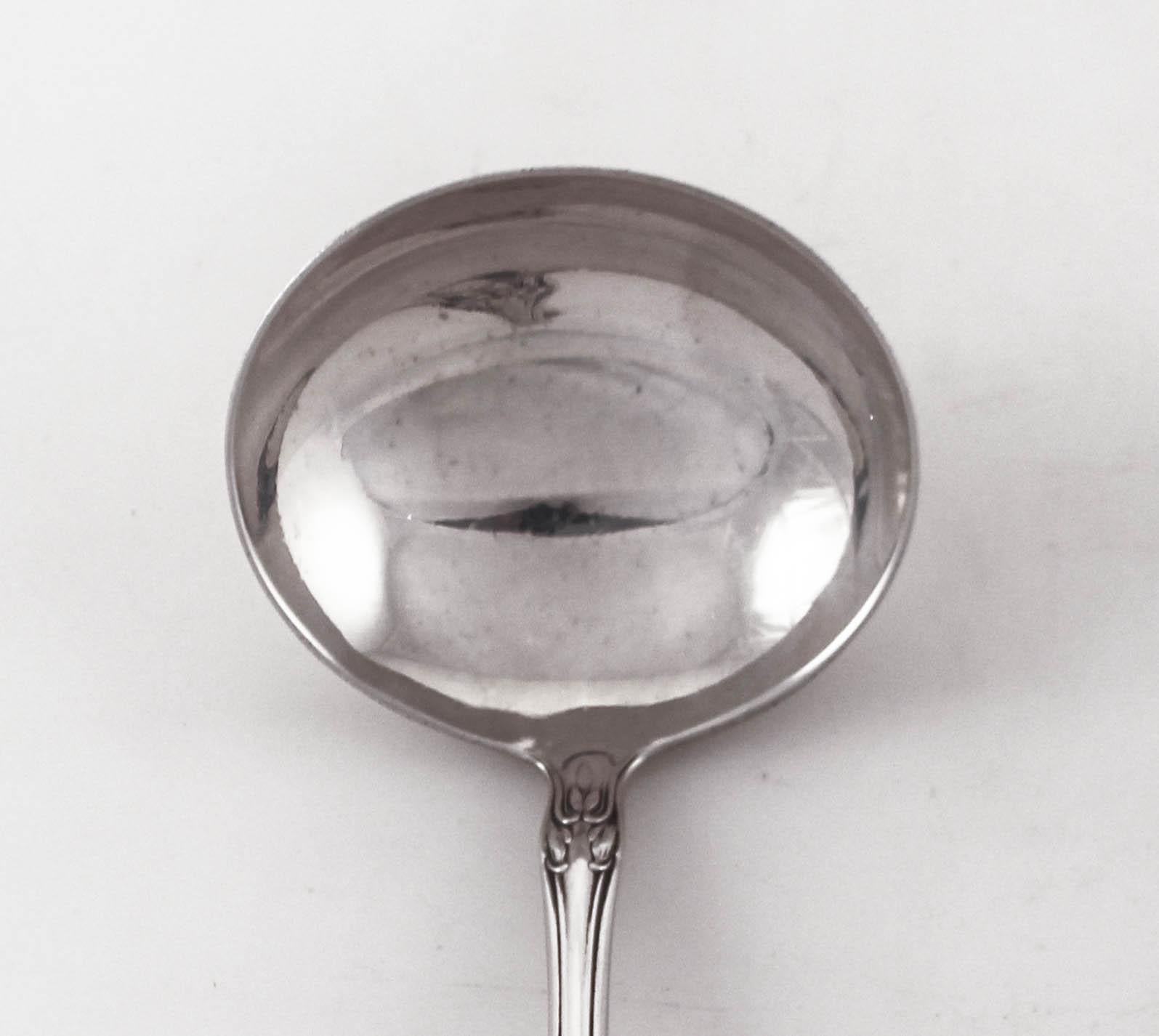 Being offered is a sterling silver gravy ladle in the “Chateau Rose” pattern by the Alvin Silver Company from 1941. It has a scalloped handle with flowers along the rim. It has an understated design in keeping with the period of WWII.