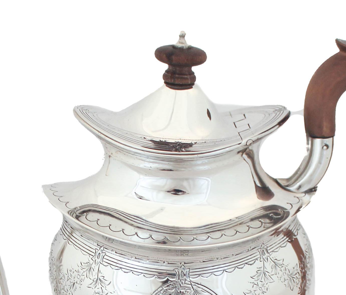 We are happy to offer you this sterling silver chocolate pot. It has a French look to it but is in fact American, early 20th century. The base is rectangular and frames the pot. Along the top etched garlands and leaves drape the cartouche. In the