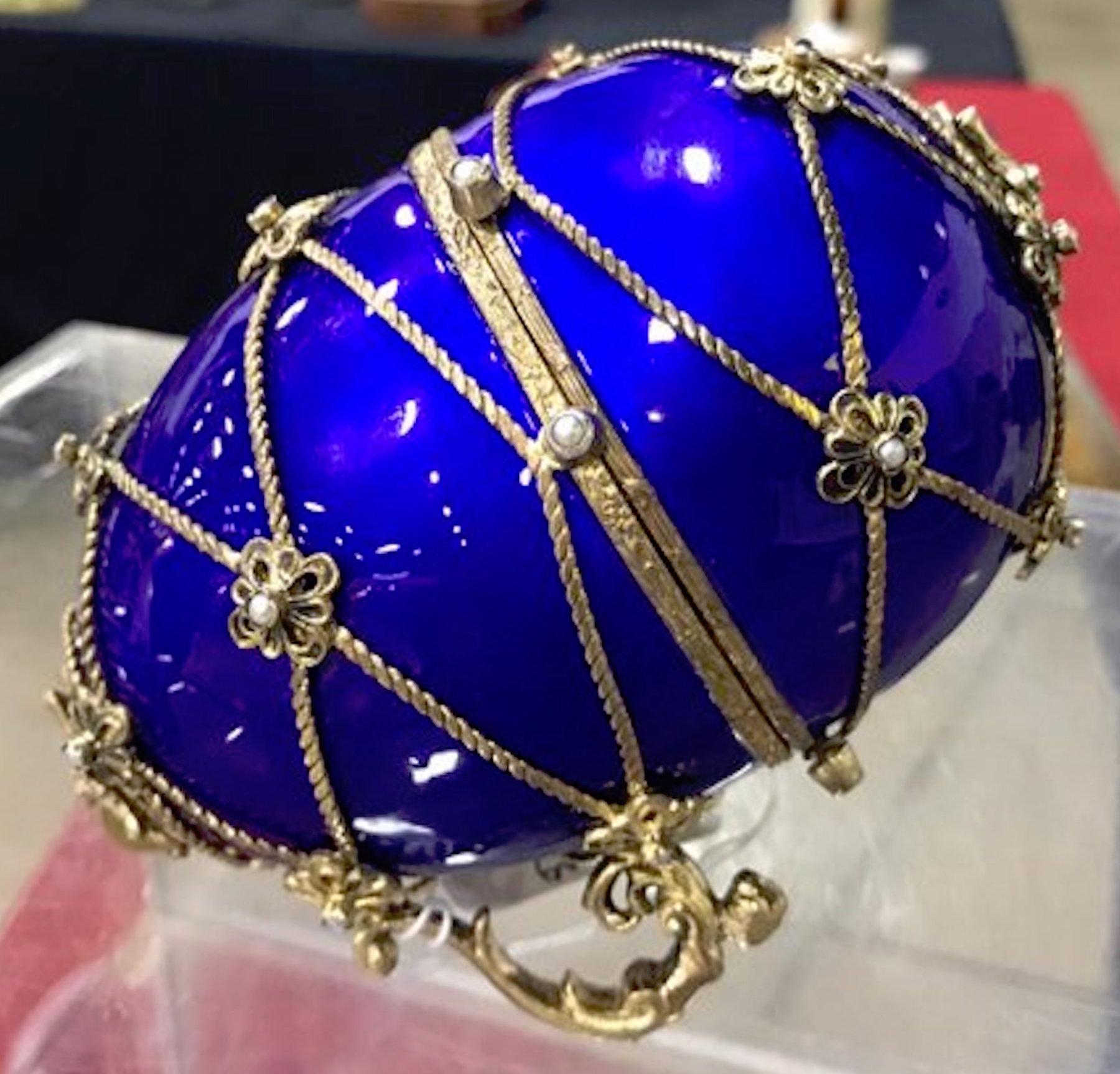 Sterling and cobalt blue enamel egg music box, in the style of Fabergé
Magnificent Austrian sterling silver gilt and enamel music box with carriage 
Constructed in two pieces with a removable associated silver gilt carriage
The egg stands on two